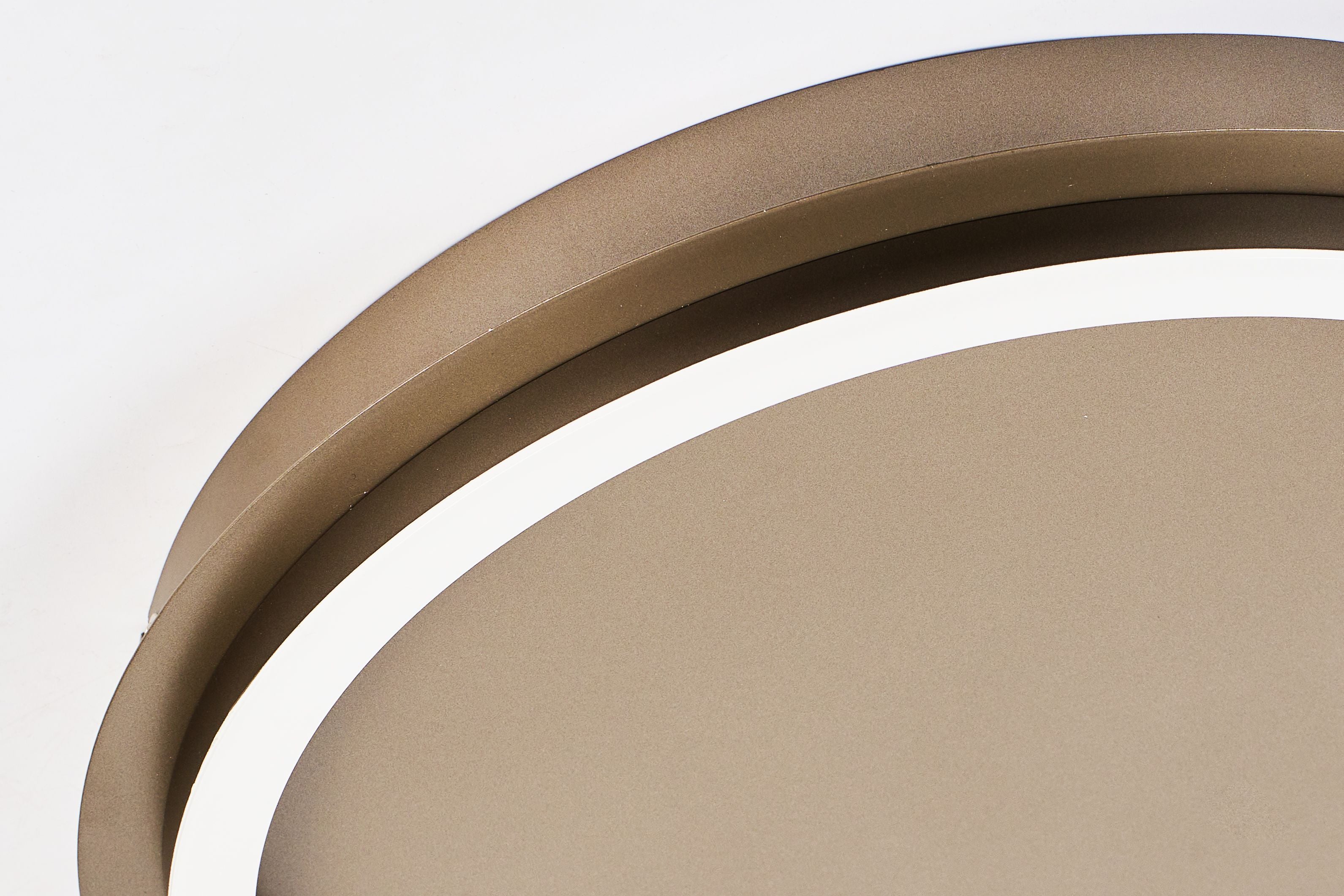 Close up of the Searchlight Stellar LED ceiling lamp in latte metal showing the lit acrylic diffuser ring against the warm bronze toned frame