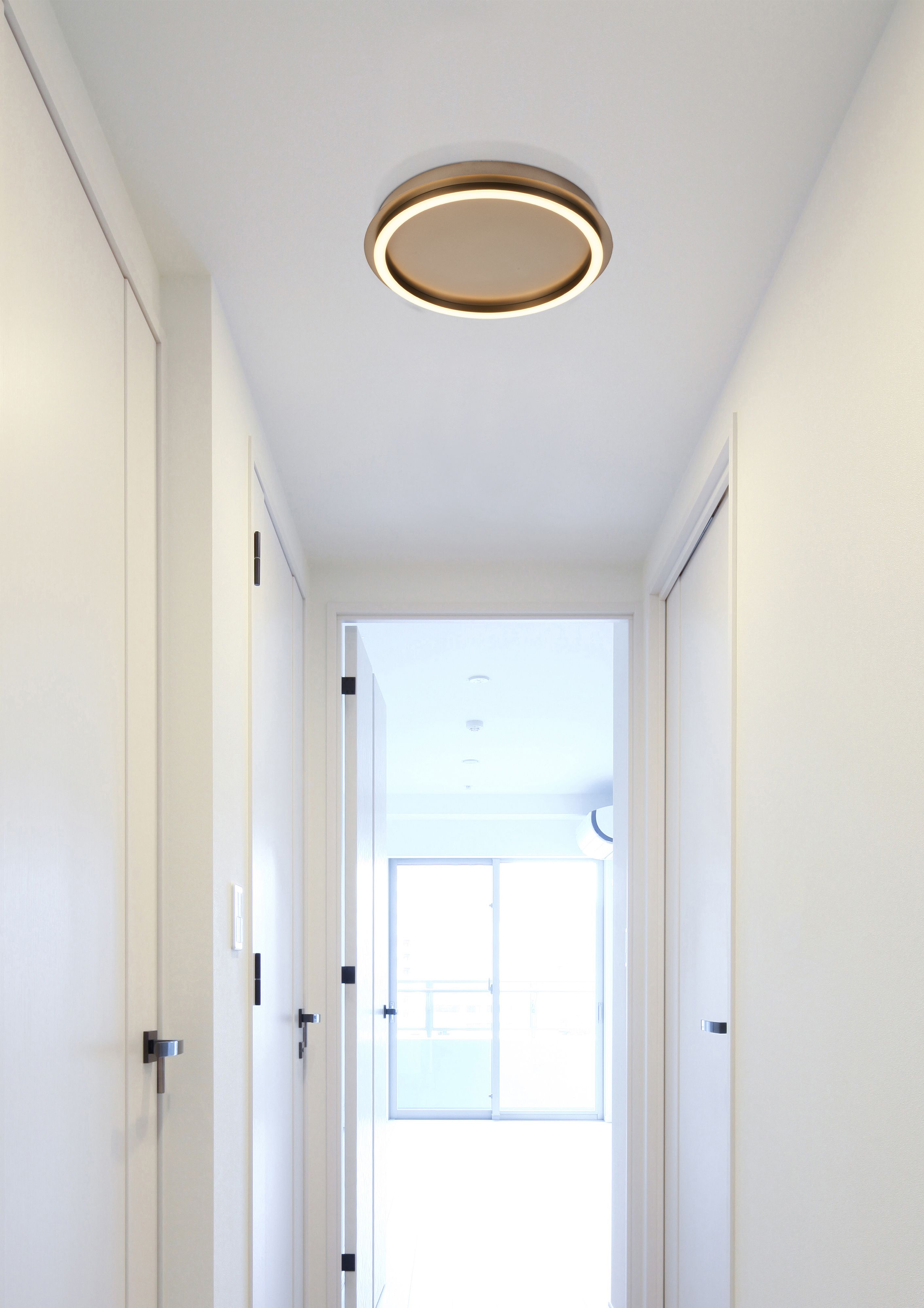Searchlight Stellar LED ceiling lamp in latte metal fitted in a hallway ceiling with white panelled doors, glowing warm white