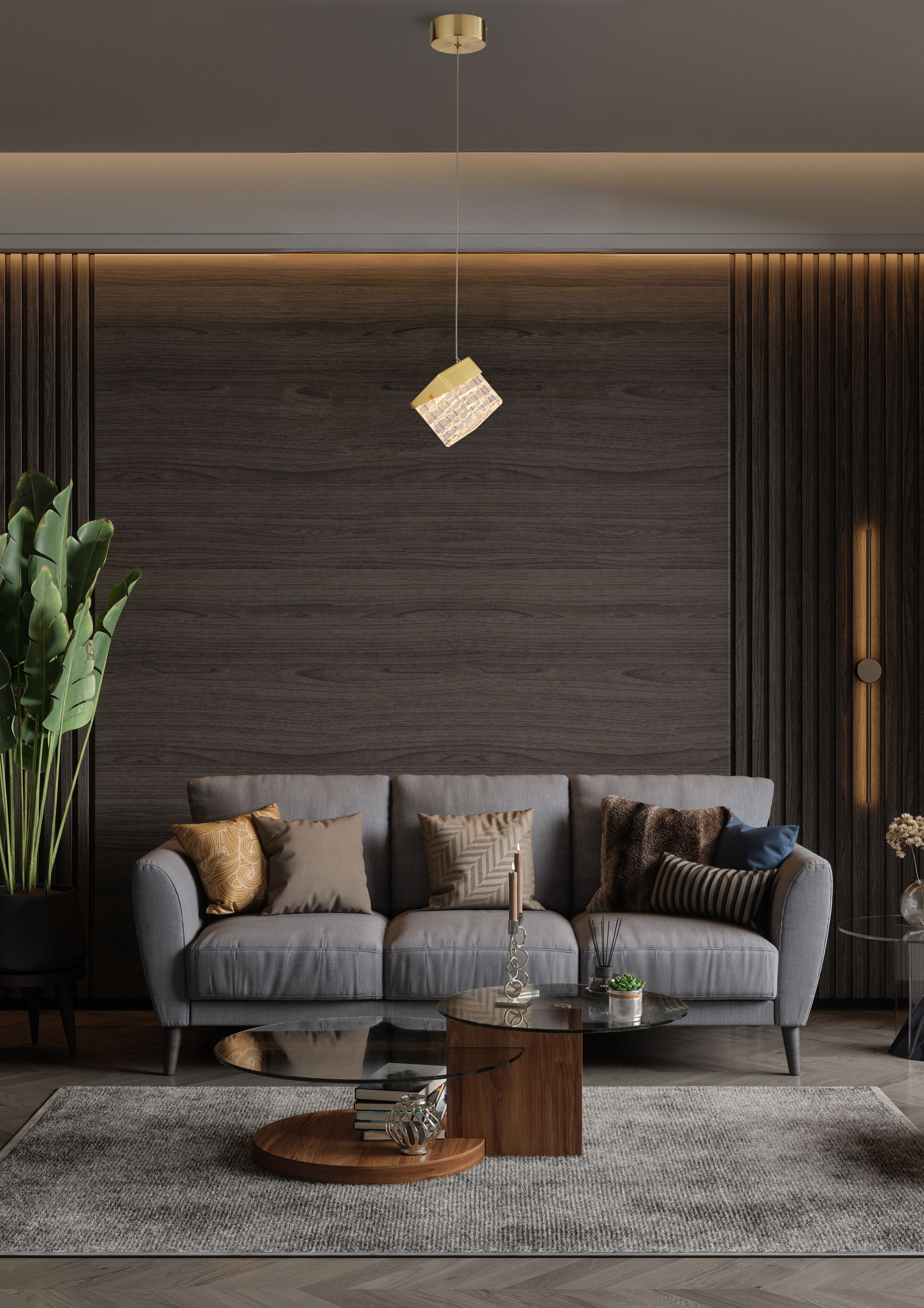 Searchlight Cuboid LED Pendant in satin brass styled low over a coffee table in a dark, moody living room with a sofa and large plant