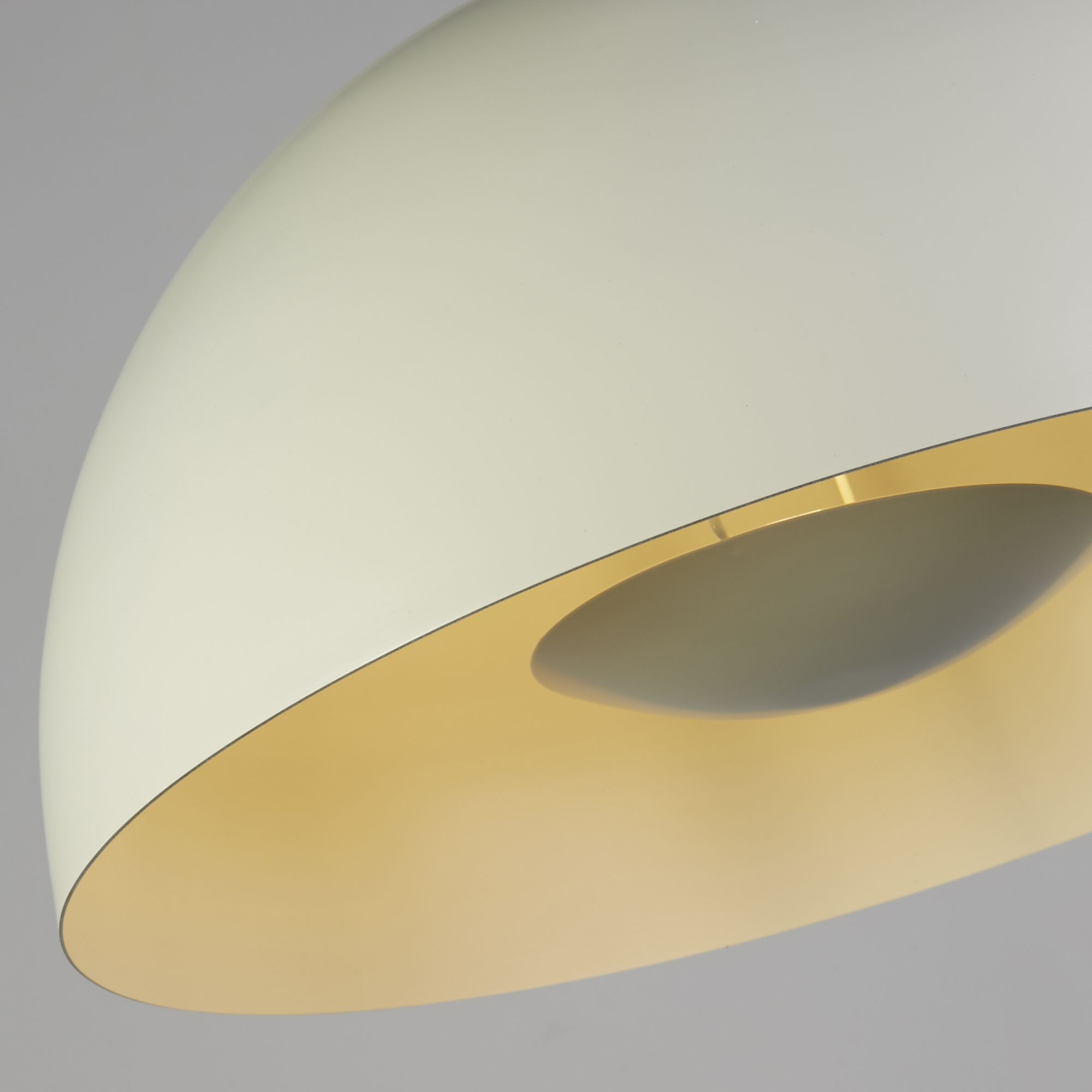 Close up of the Mars pendant's rim, showing the matt cream exterior meeting the pale gold interior of the dome shade