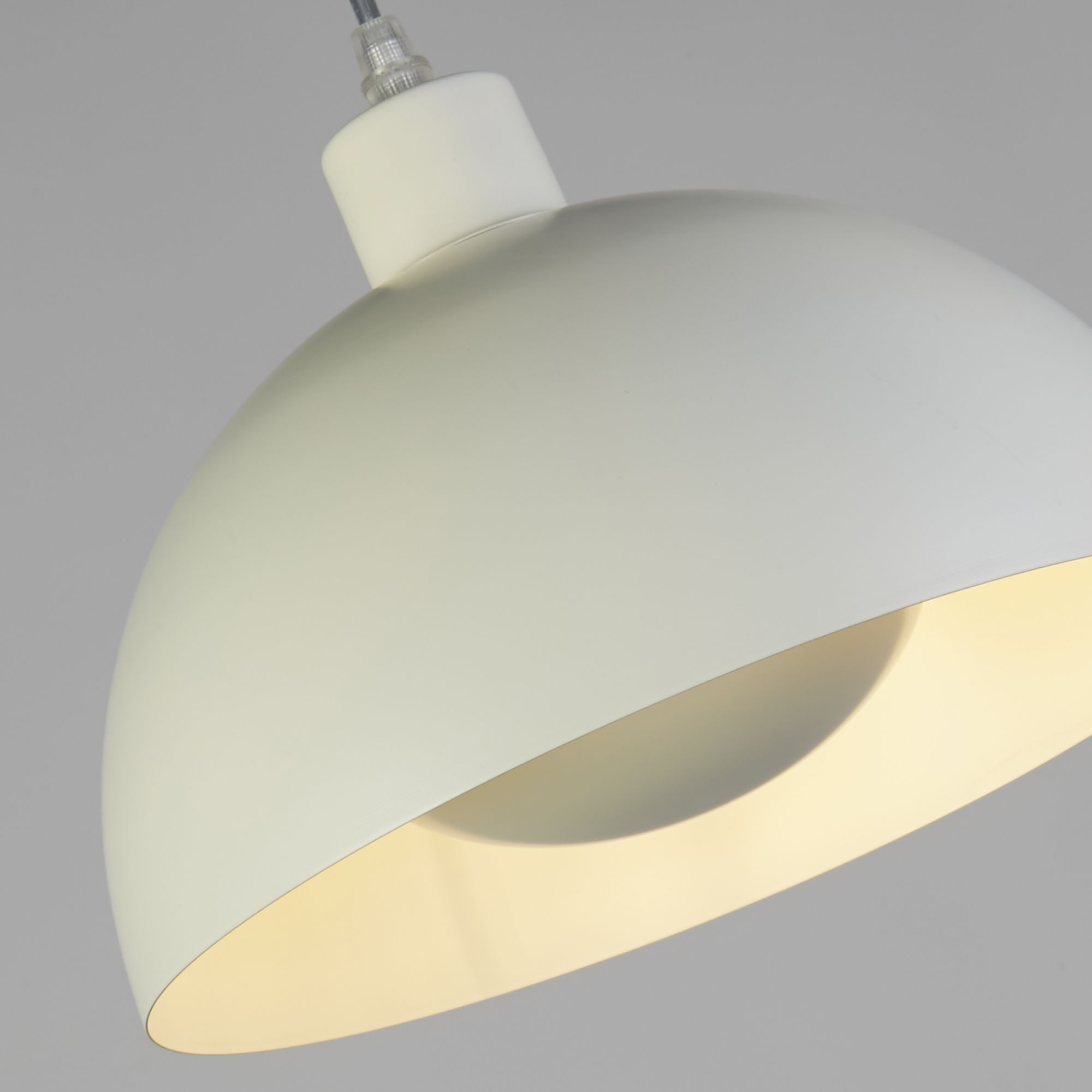 Close up of the Mars pendant's rim, showing the matt cream exterior meeting the pale gold interior of the larger dome shade