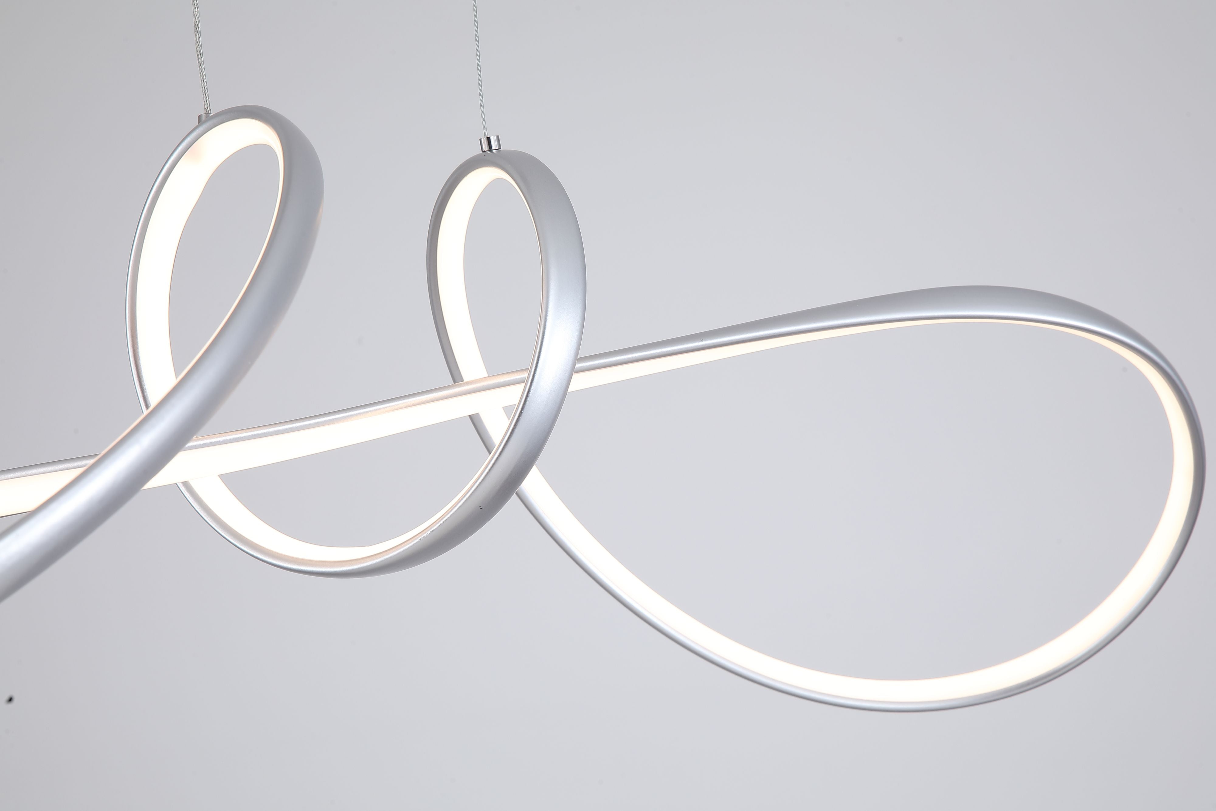 Close up angled detail of the Maisie pendant's crossing loops, showing the brushed grey finish and illuminated diffuser