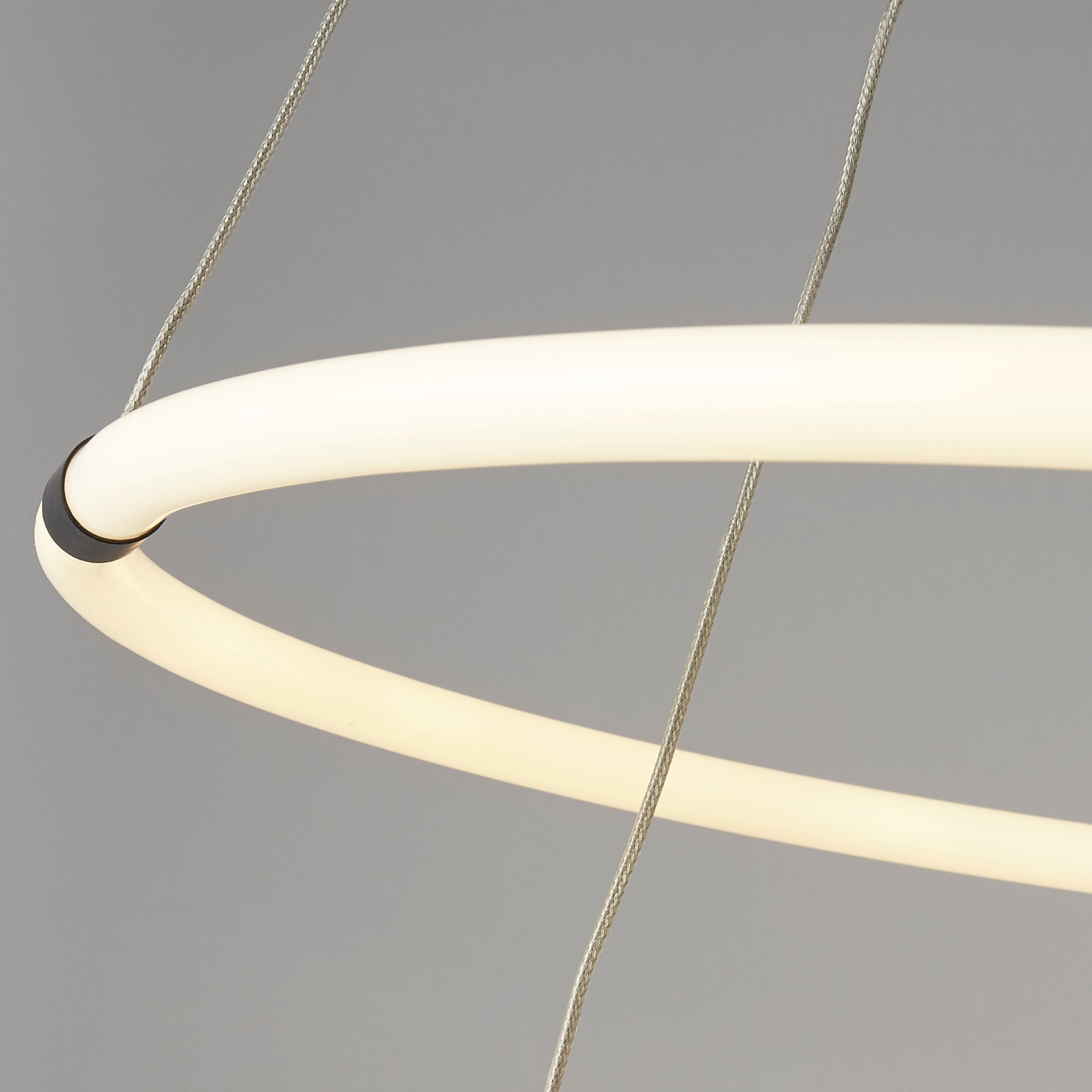 Close up of the Revolve 2 light ring pendant showing the opal tube joins and the suspension cables crossing between the two rings