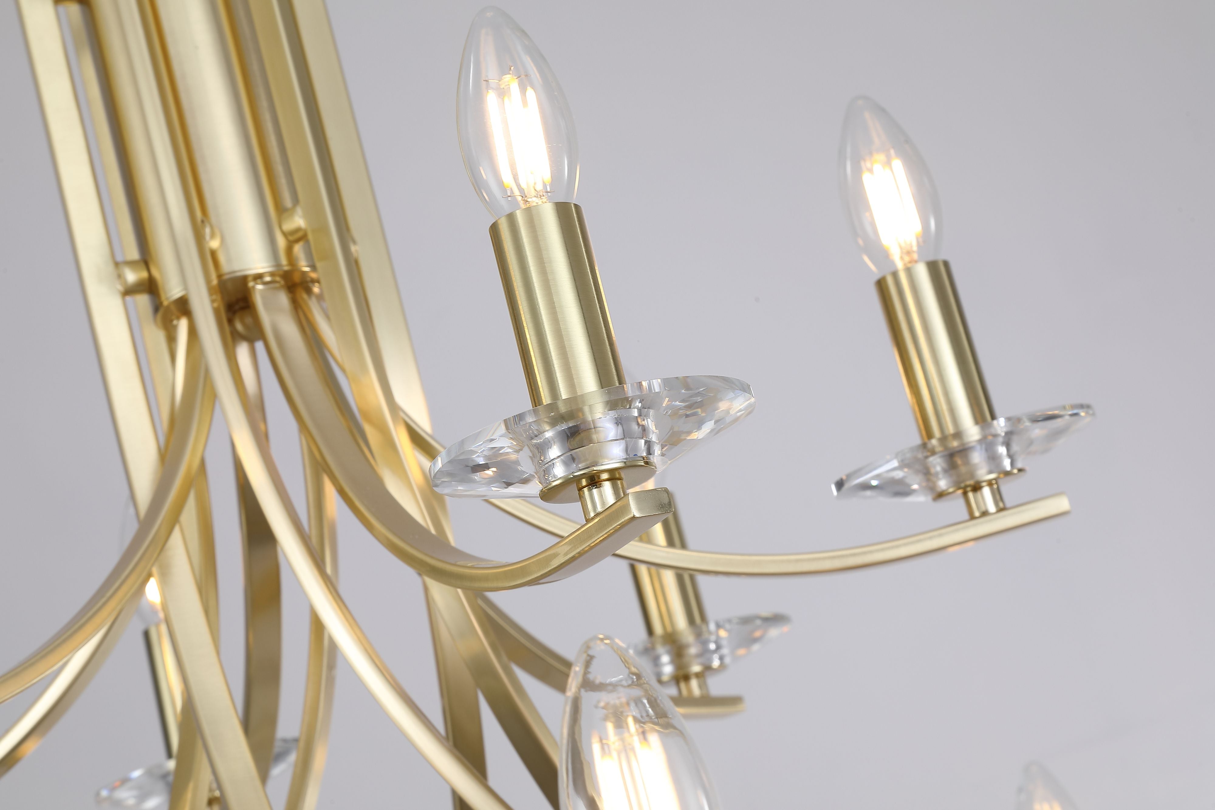 Close up of the Ascona 12 Light Pendant showing candle bulbs on satin brass arms with faceted crystal style sconces beneath each bulb