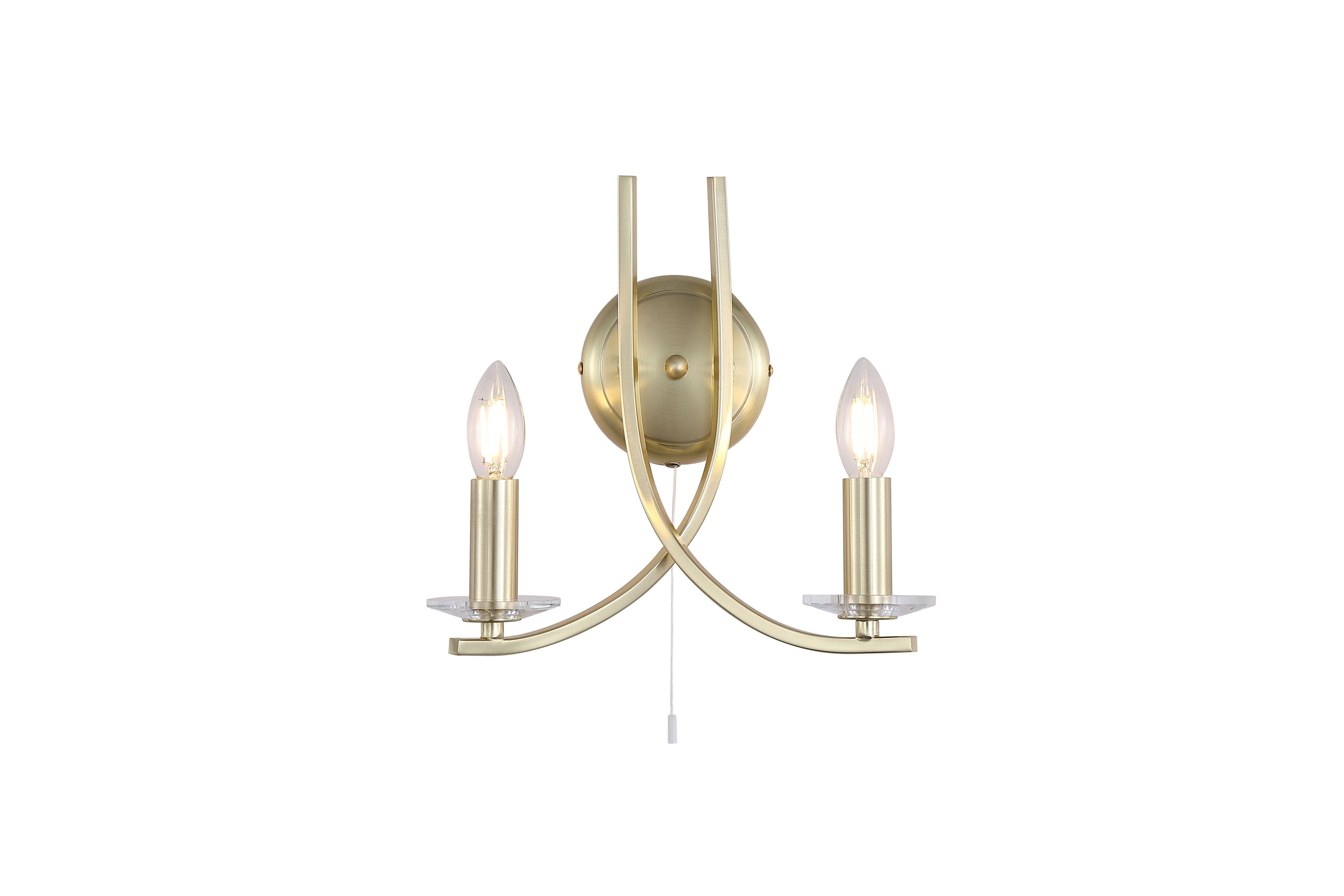 Searchlight Ascona 2 Light Wall Light in satin brass, full fitting on a white background, showing two curved crossed arms with lit candle bulbs and a pull cord switch