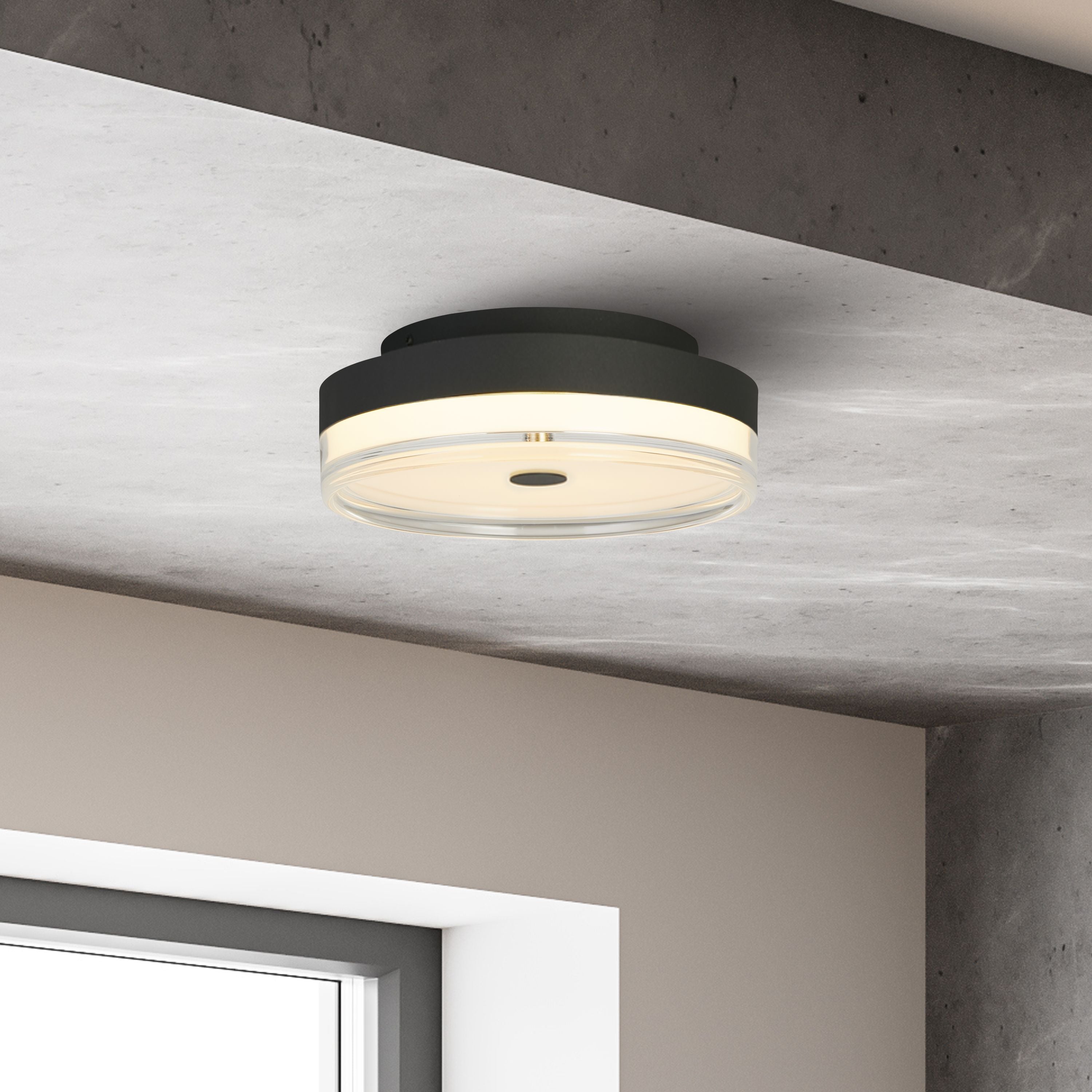 Searchlight Cyprus 30cm LED flush ceiling light in black, fitted to a concrete ceiling beam in a modern interior