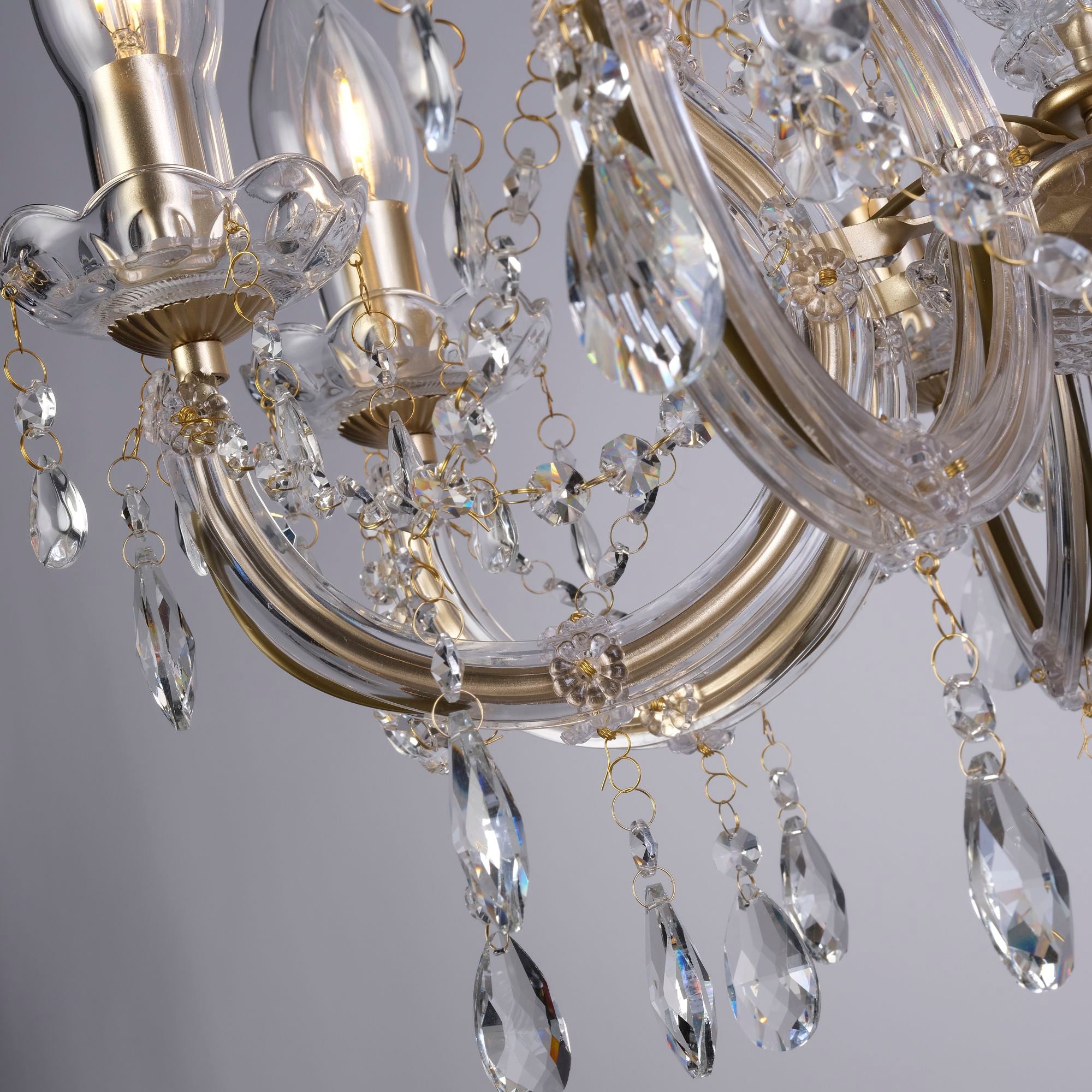 Close up of the Utah pendant's gold scrolled arms and faceted crystal droplets