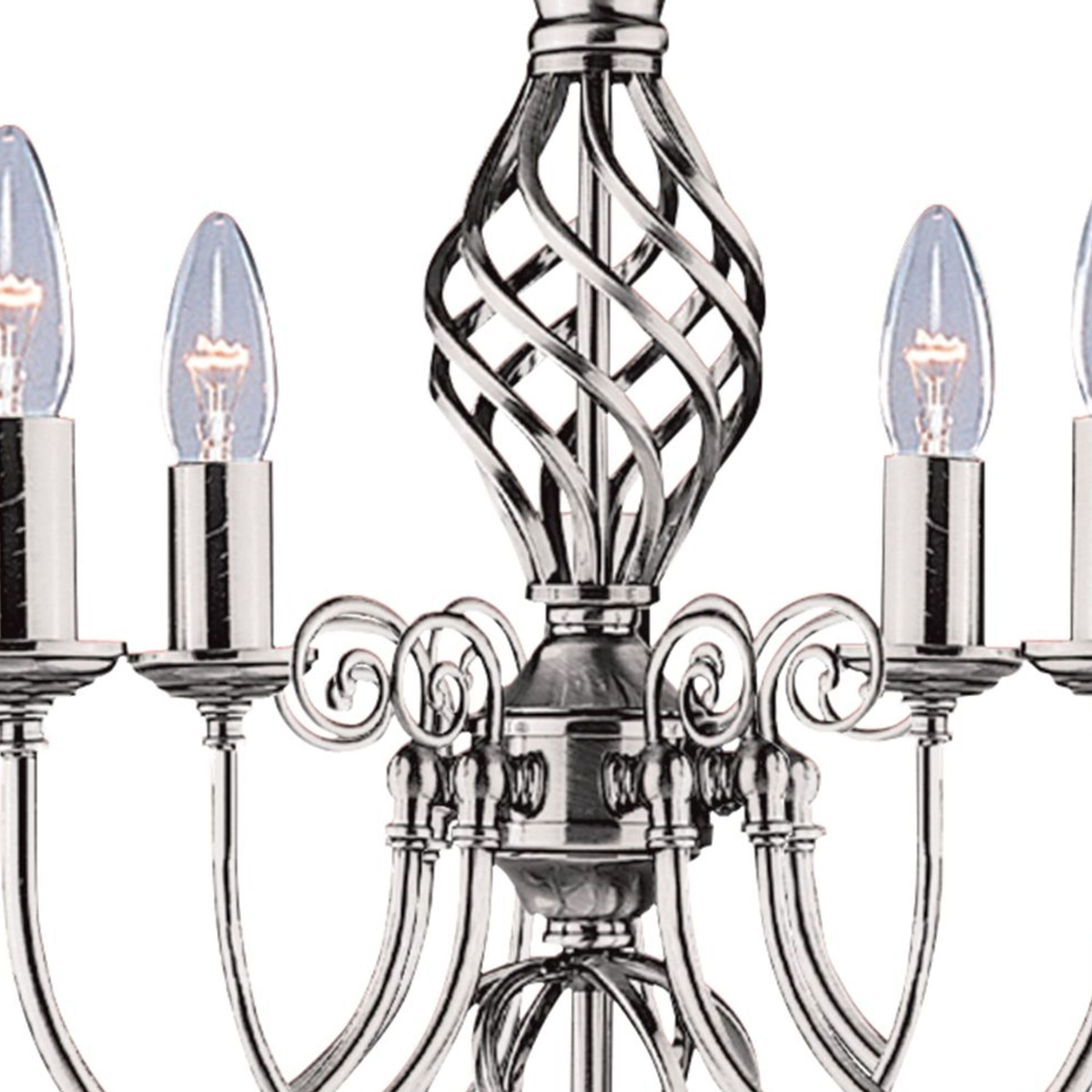Close up of the Zanzibar pendant's hand twisted central column and ornate scrolled detailing in satin silver