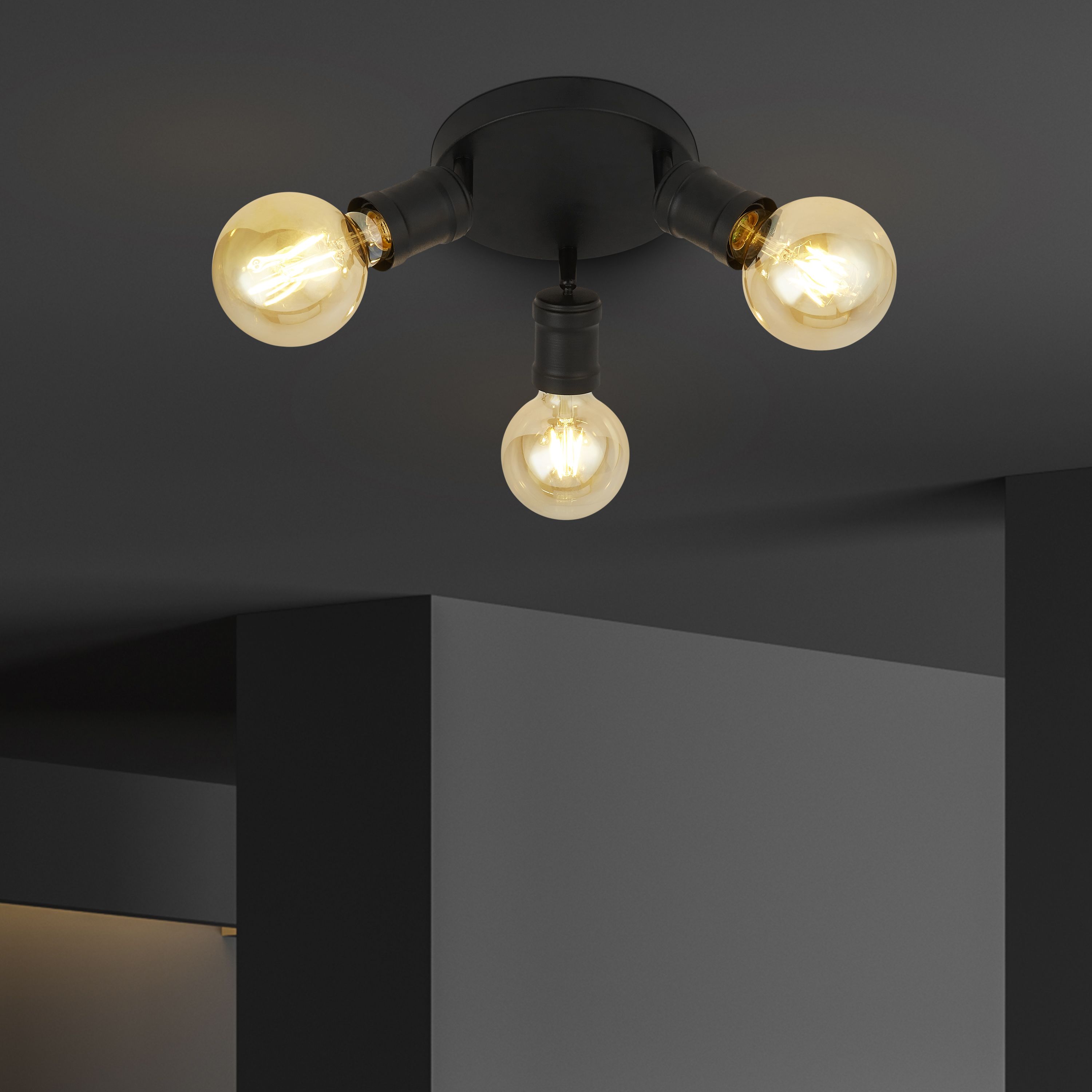 Searchlight Dance 3 light flush ceiling light styled in a dark painted room, three vintage style bulbs lit