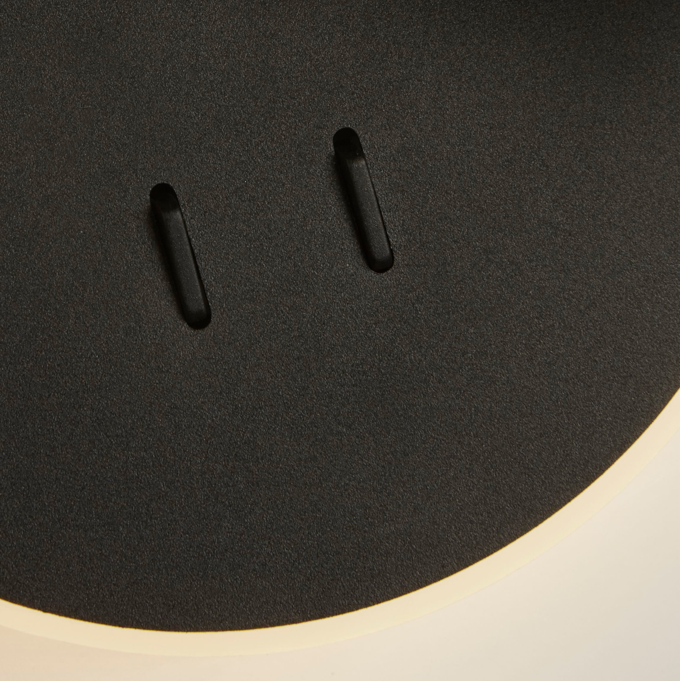 Close up of the two black rocker switches on the Cher wall light's backplate, which independently control the spotlight and the ambient ring