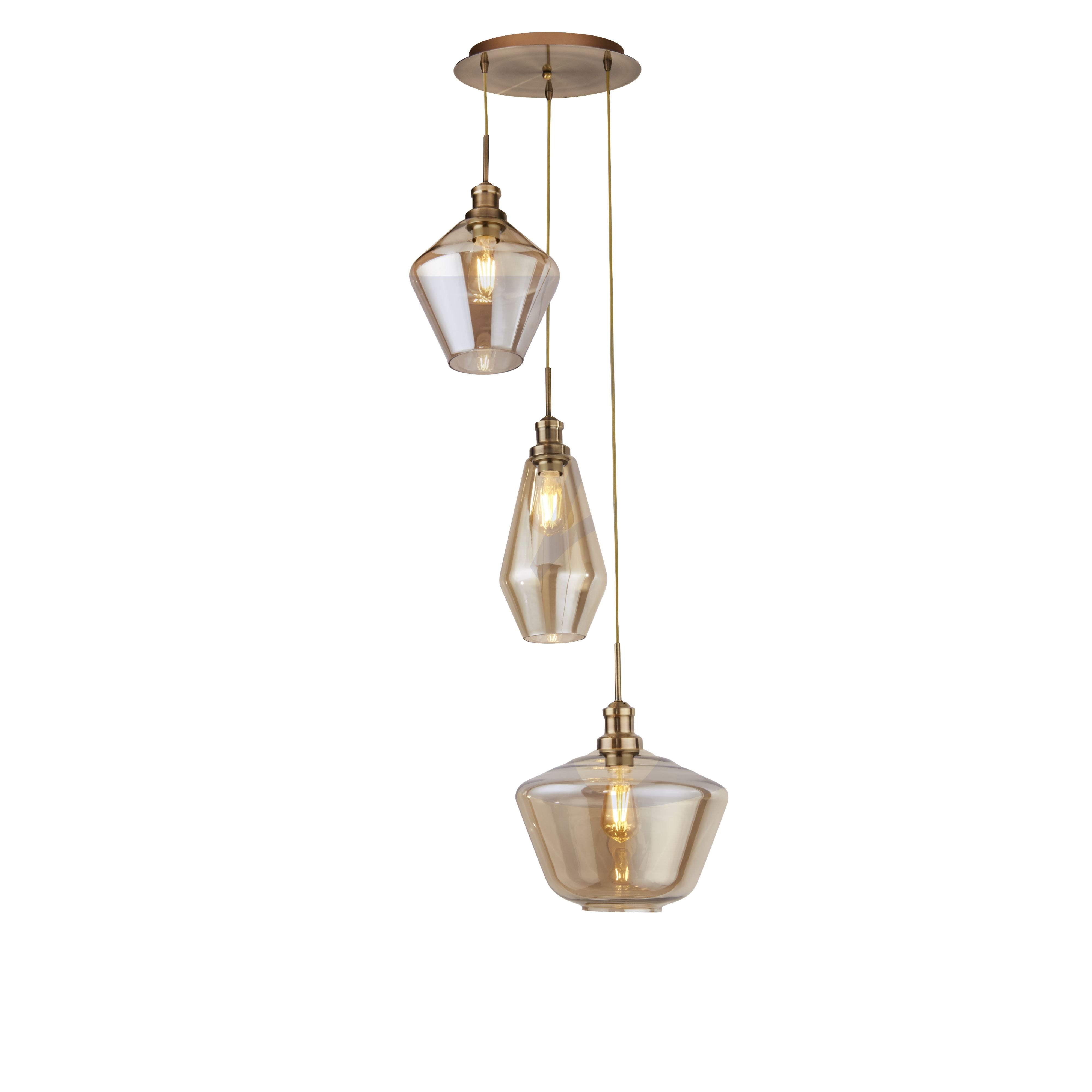 Searchlight Mia 3 light multi drop pendant in antique brass, three graduated amber glass shades hung at staggered heights from a round brass ceiling plate on a white background