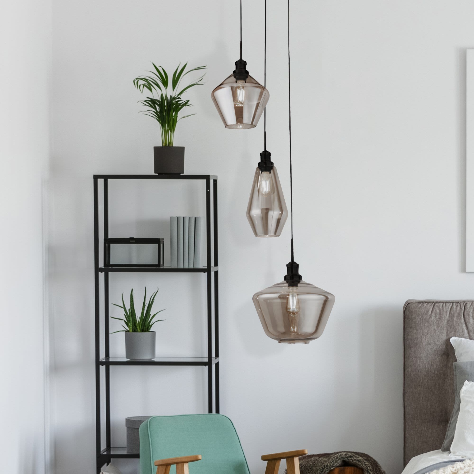 Searchlight Mia 3 light multi drop pendant in black and smoked glass styled beside a bookshelf with plants in a bright bedroom