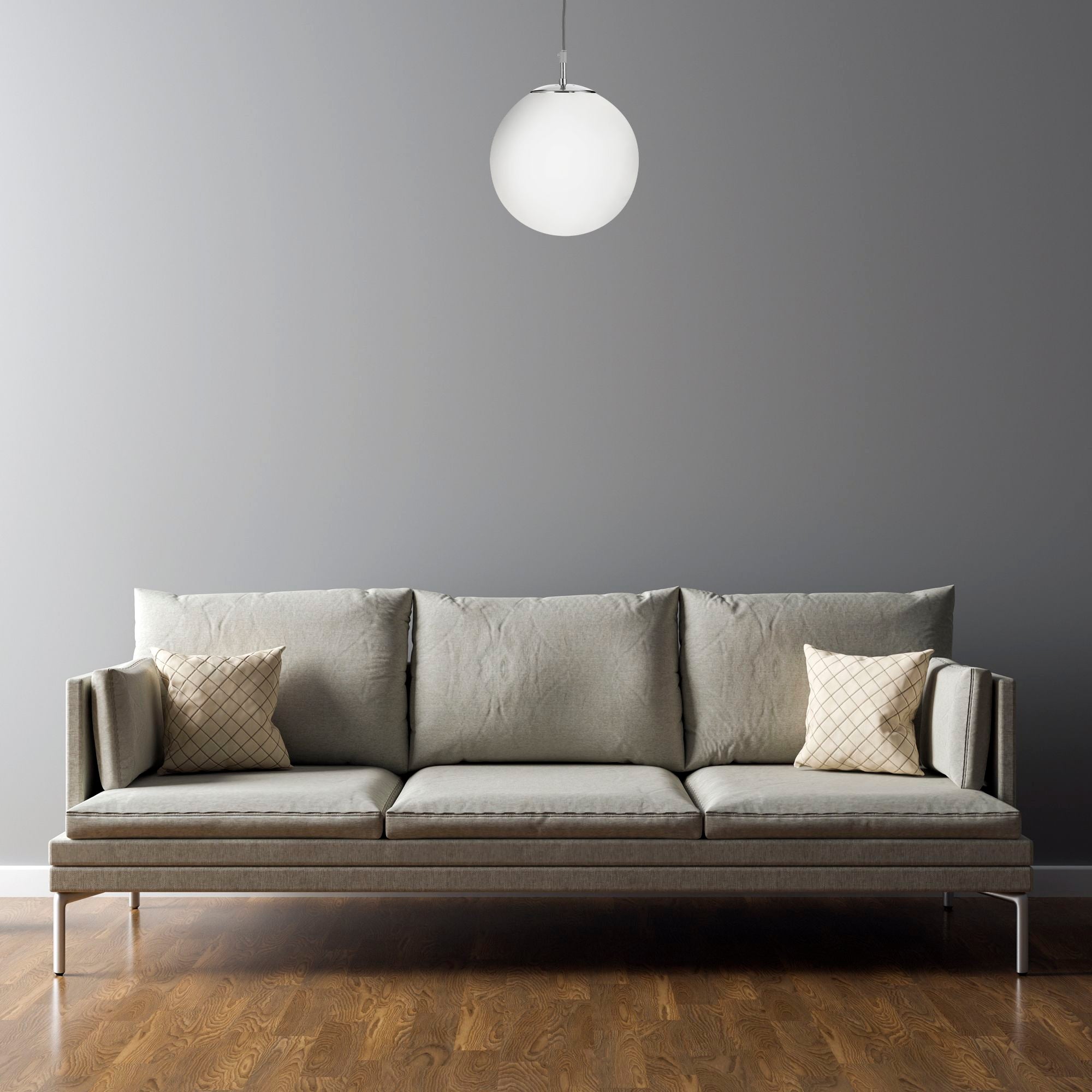 Searchlight Atom Pendant in satin silver and opal glass styled above a grey sofa in a plain grey walled living room
