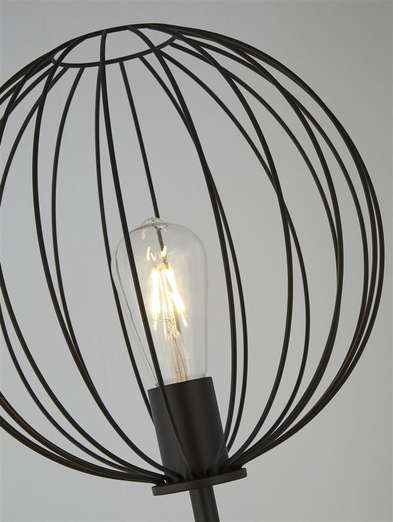 Close up of the Rondo floor lamp's black wire globe shade with the exposed light bulb visible inside