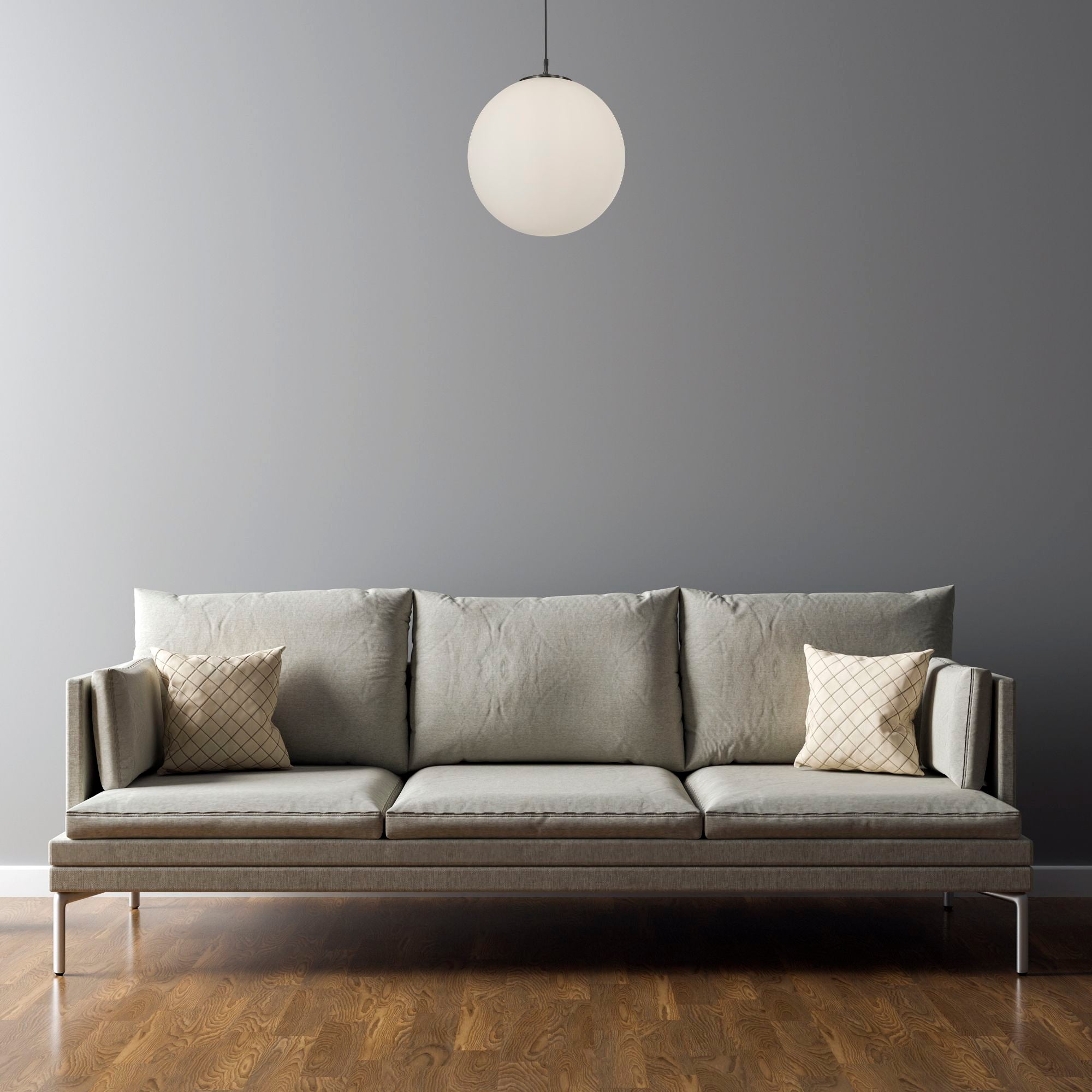 Searchlight Atom Pendant in matt black and opal glass styled above a sofa in a grey walled living room