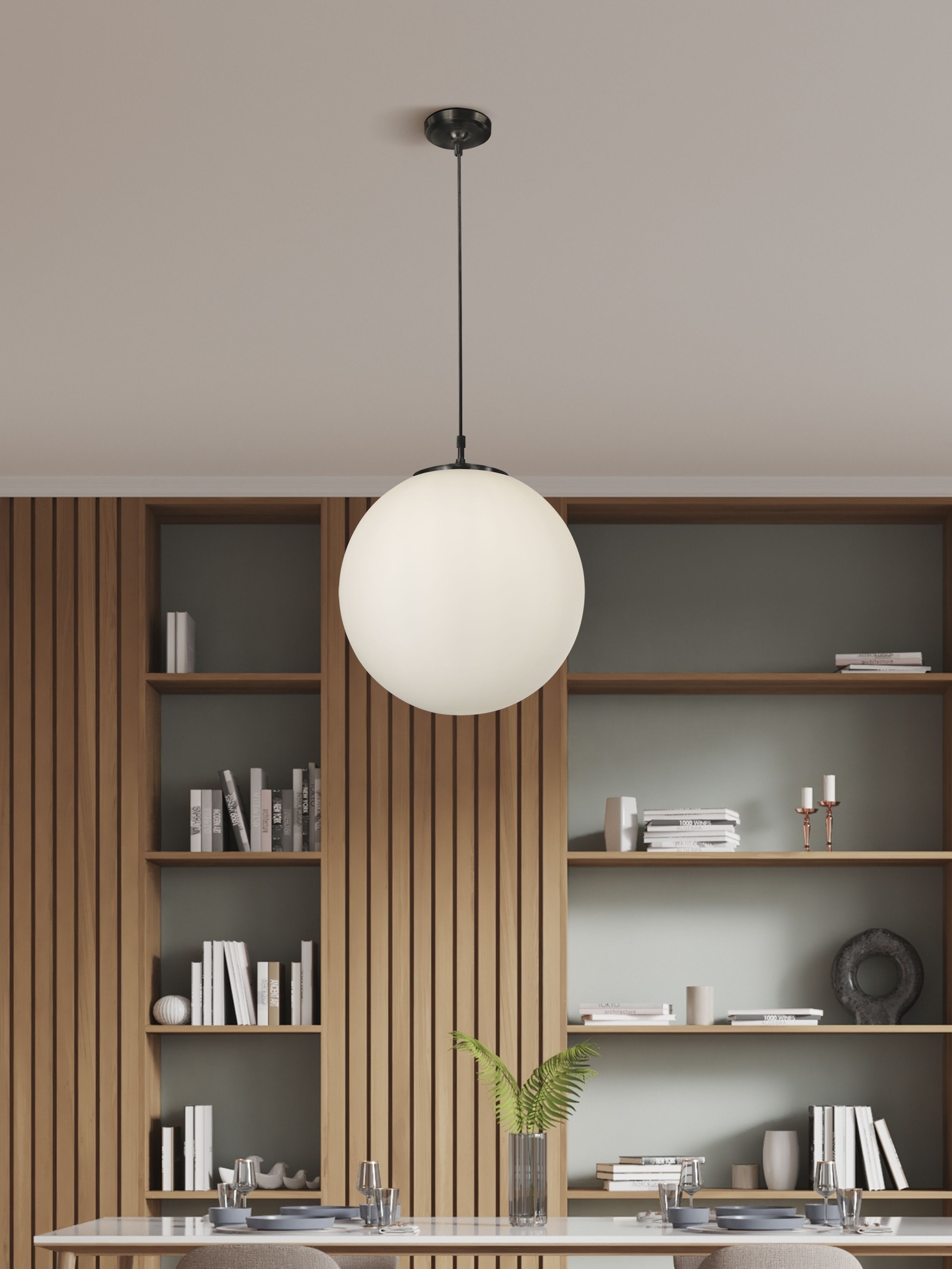 Searchlight Atom pendant styled above a dining table in a room with wood slat shelving, the opal glass globe glowing softly against black metal fittings