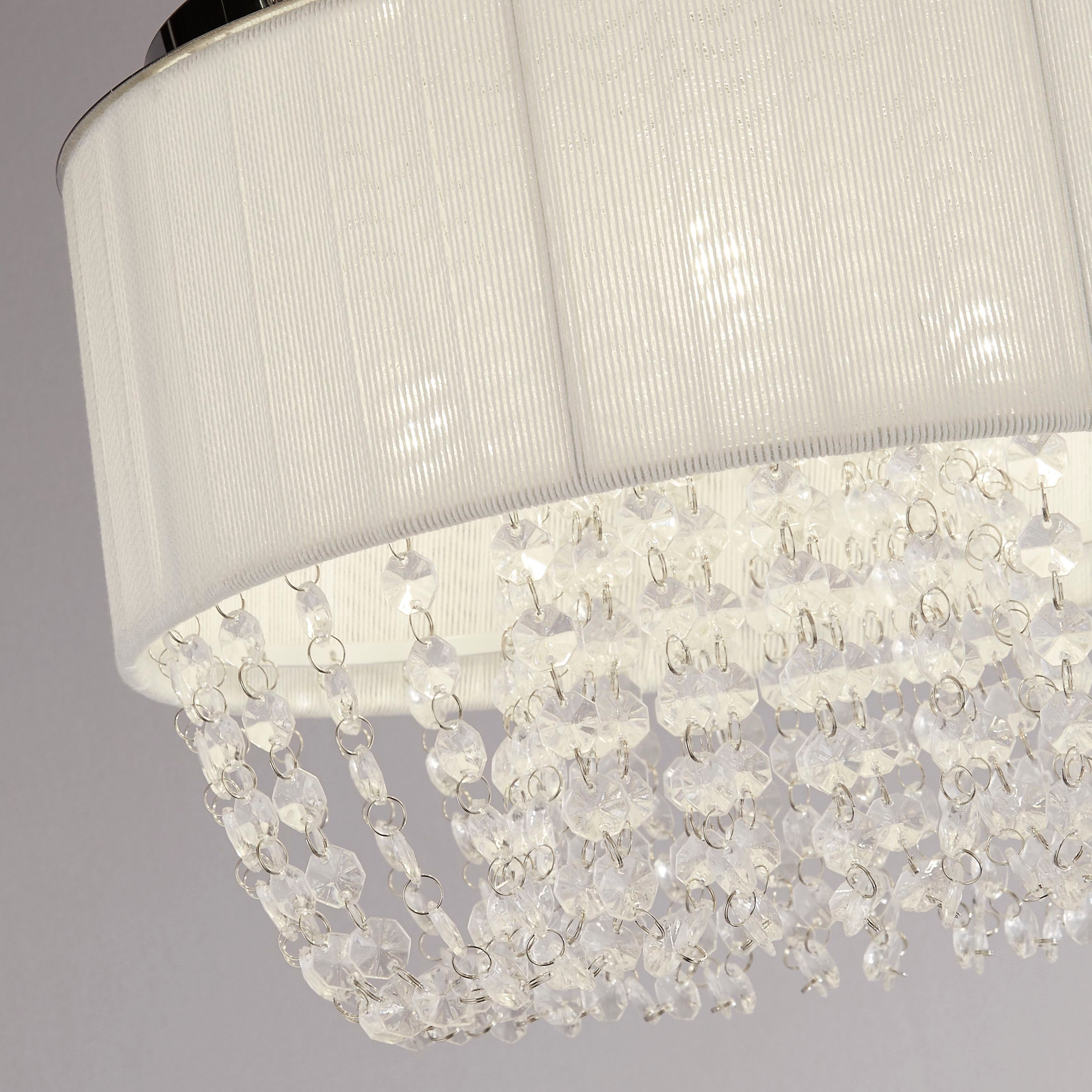 Close up of the Searchlight Bellano 3 light, showing the white pleated fabric shade, chrome trim and faceted clear acrylic droplets