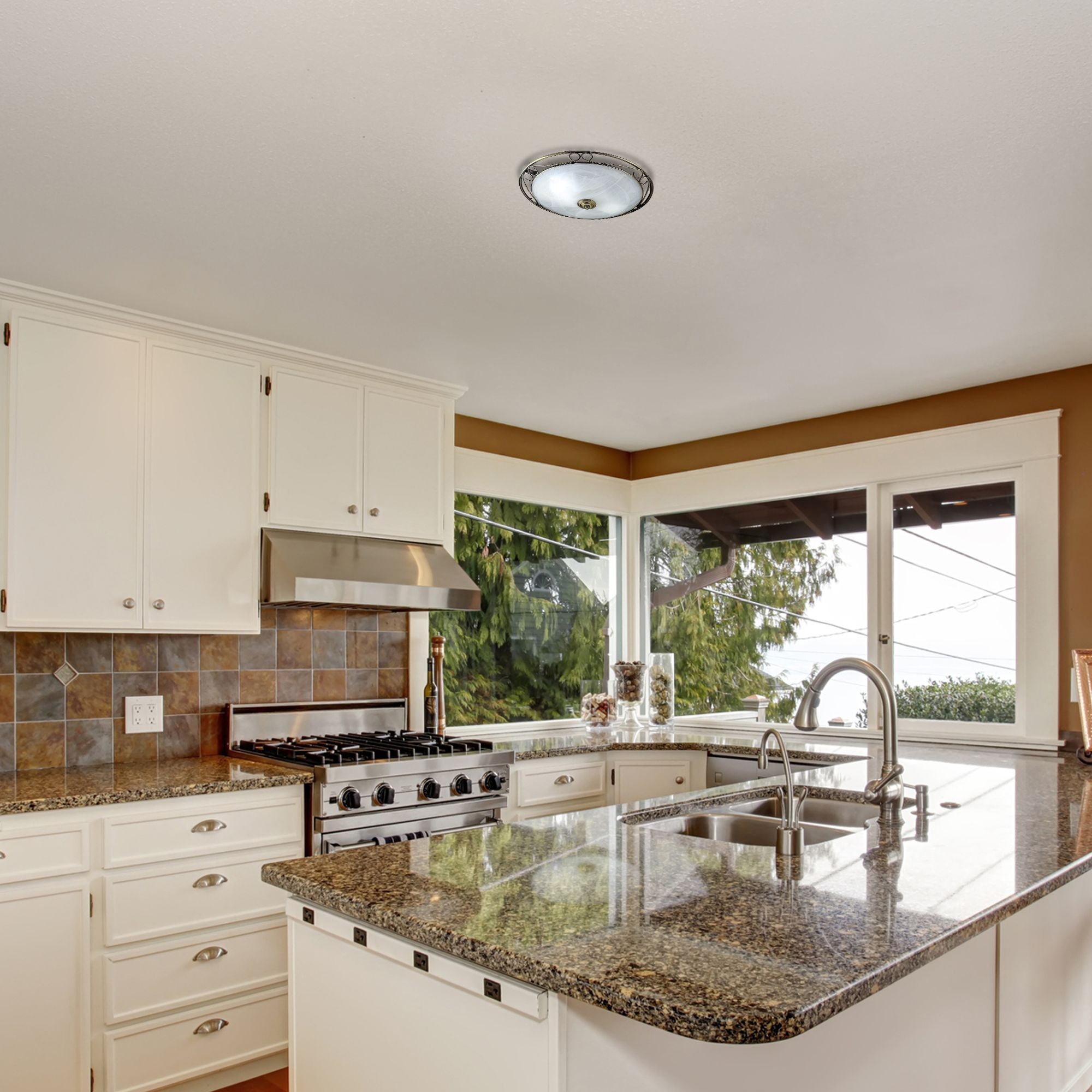 Searchlight Weybridge flush ceiling light in antique brass with alabaster glass, styled on a kitchen ceiling above a granite island