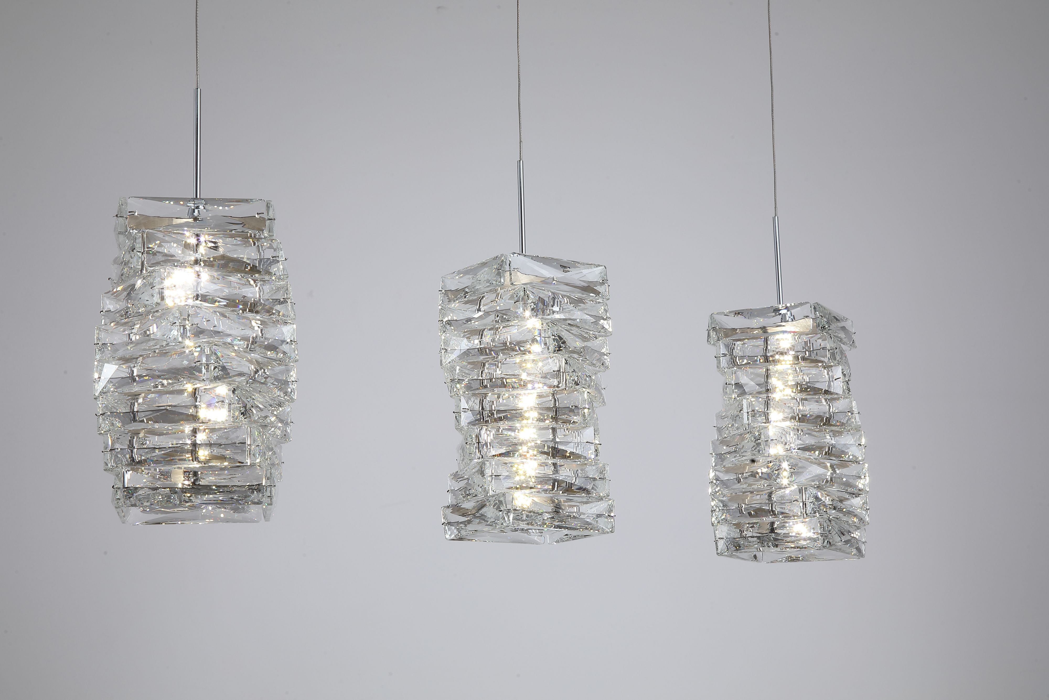 Close up of the three crystal shades on the Searchlight Modena LED 3 Light Bar Pendant, showing the layered angular crystal panels and integrated LED glow