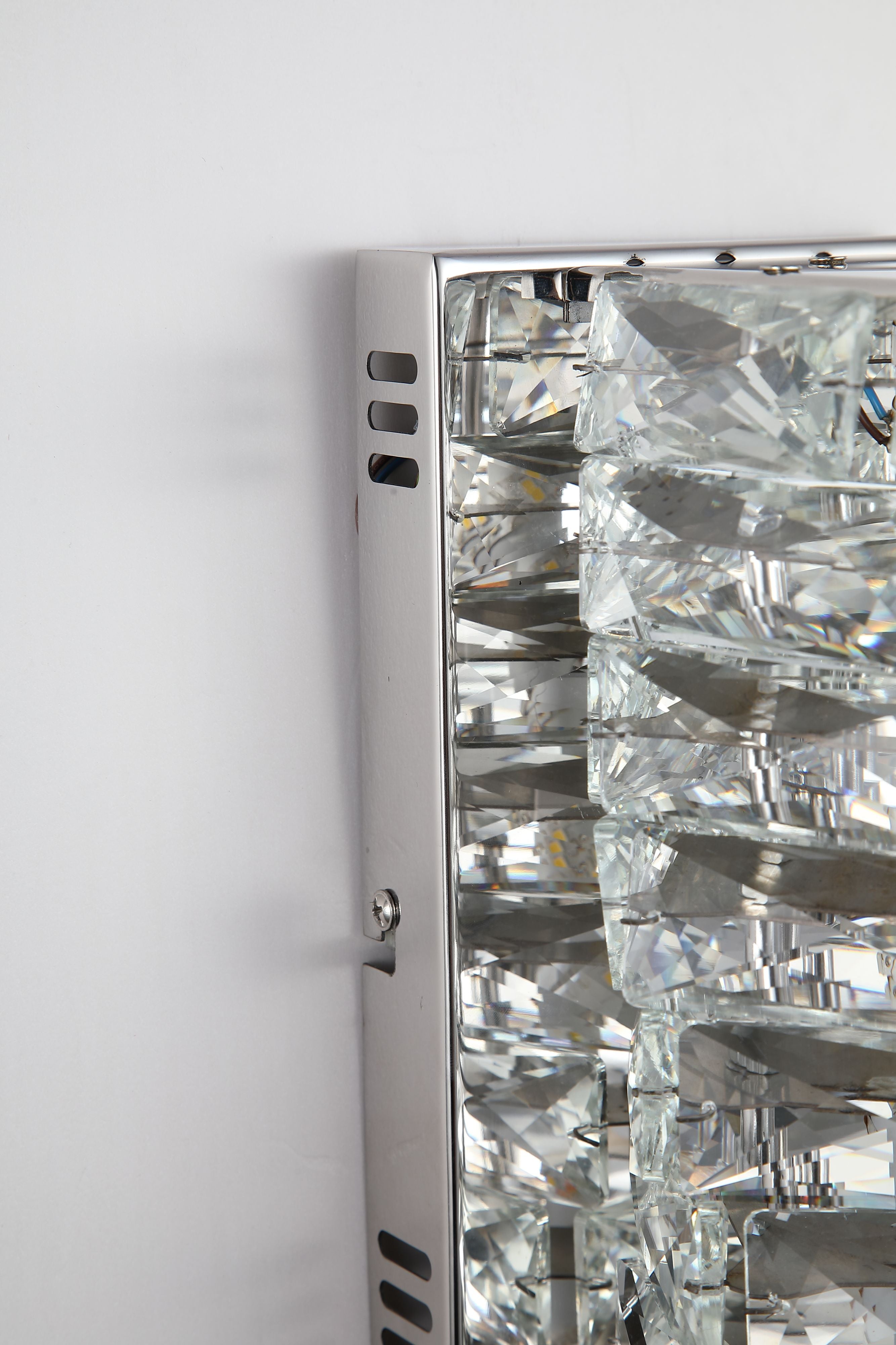 Searchlight Modena LED Wall Light in chrome and clear crystal, close up of the top corner showing the chrome frame and fixing screw