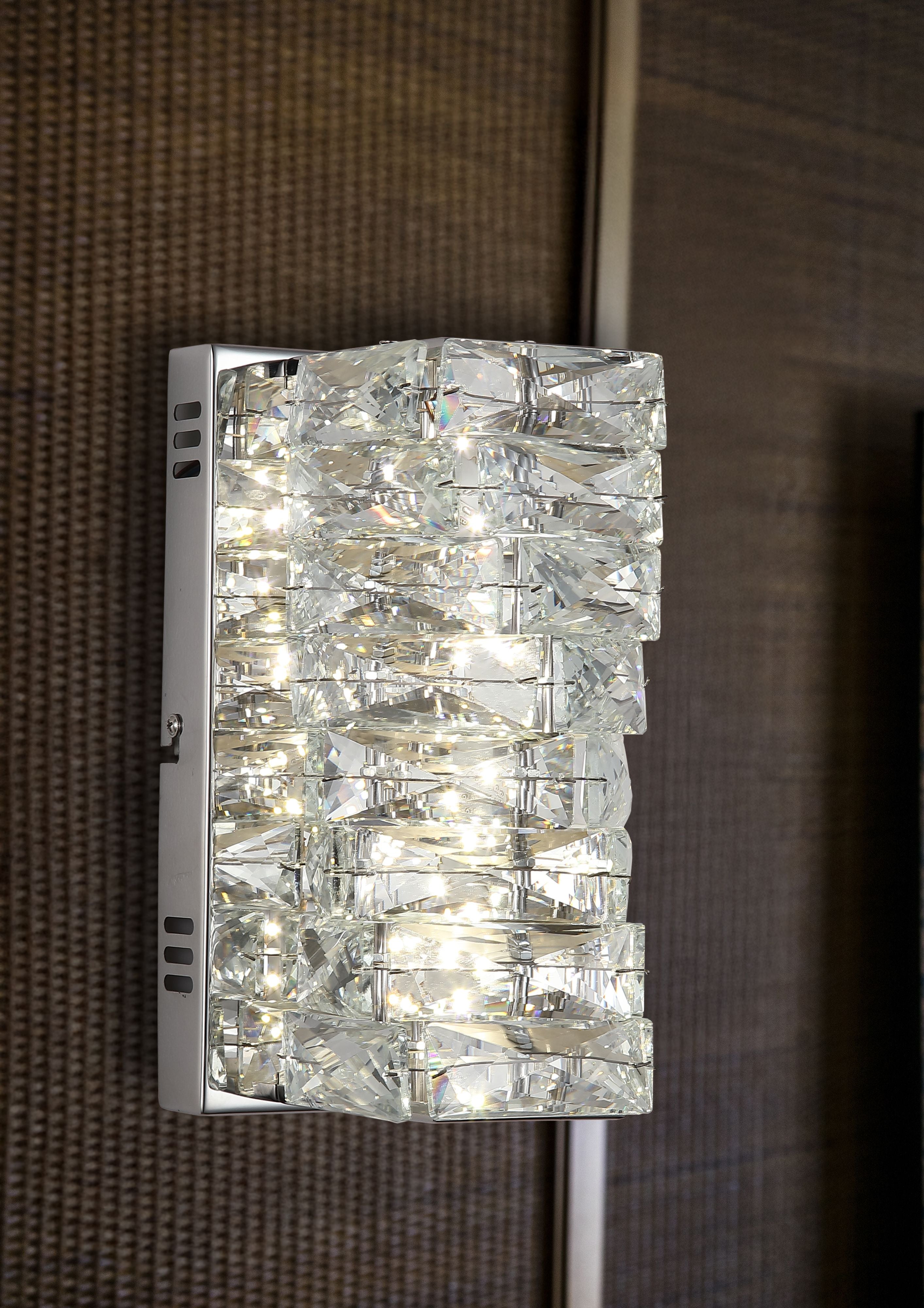 Searchlight Modena LED Wall Light mounted and illuminated on a woven textured wall