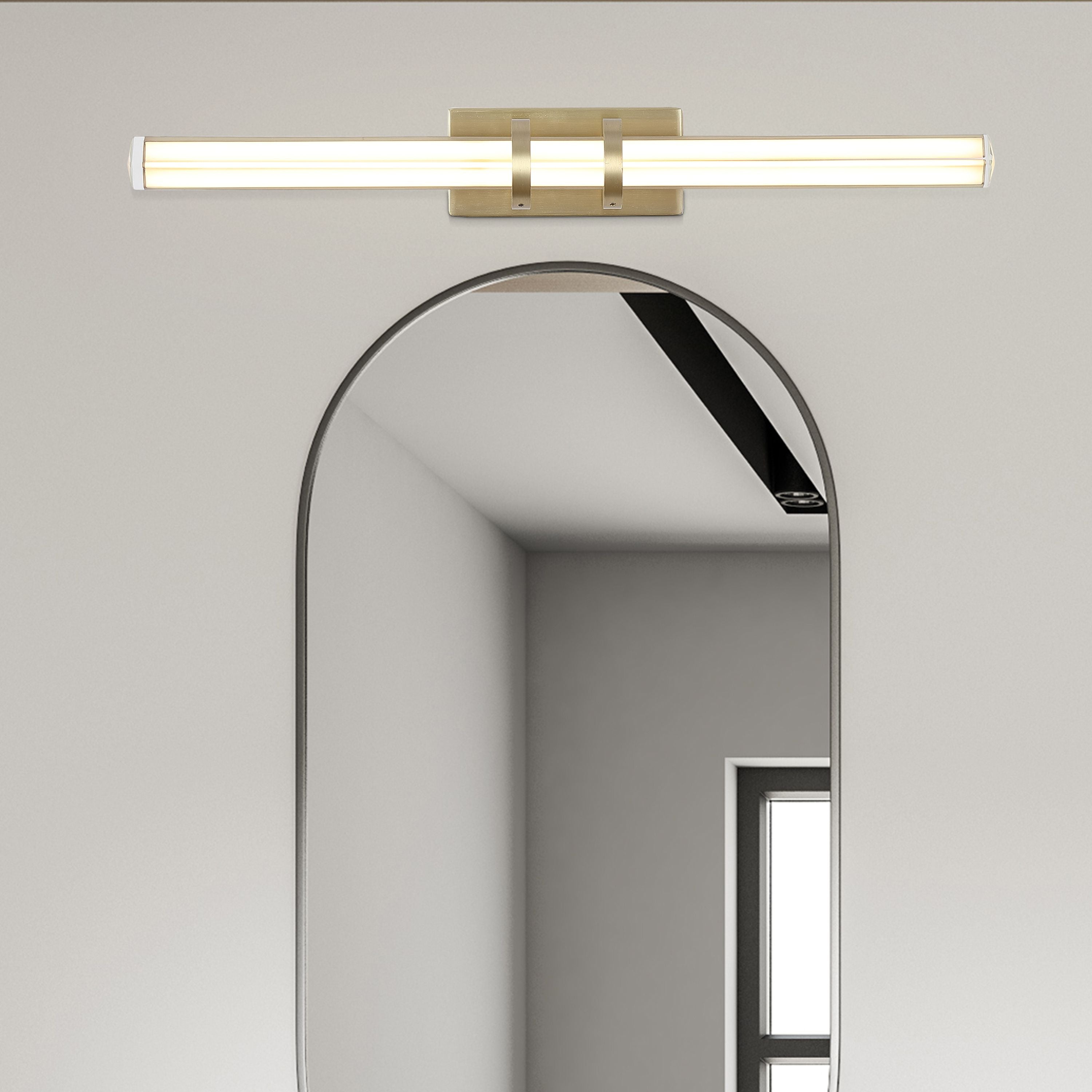 Parma LED wall light in satin brass mounted above an arched bathroom mirror, styled room setting