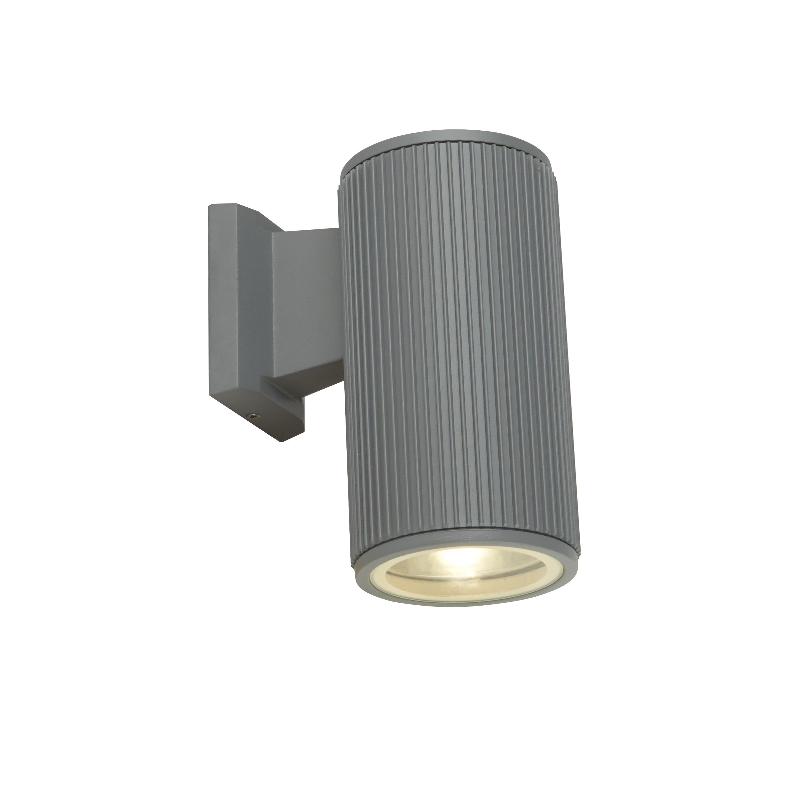 Hamburg Outdoor Wall Light in grey, front angle view of the fluted cylindrical body with the downlight glowing at its base.