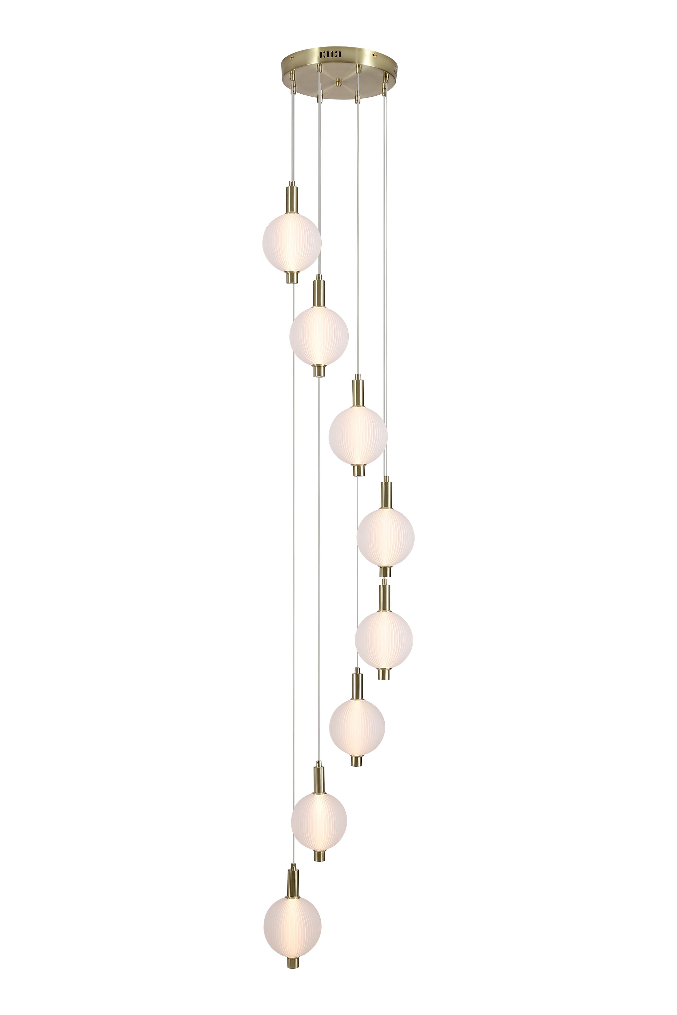 Searchlight Luminique LED 8 Light Pendant in satin brass on a white background, eight ribbed glass globes cascading at staggered heights, lit