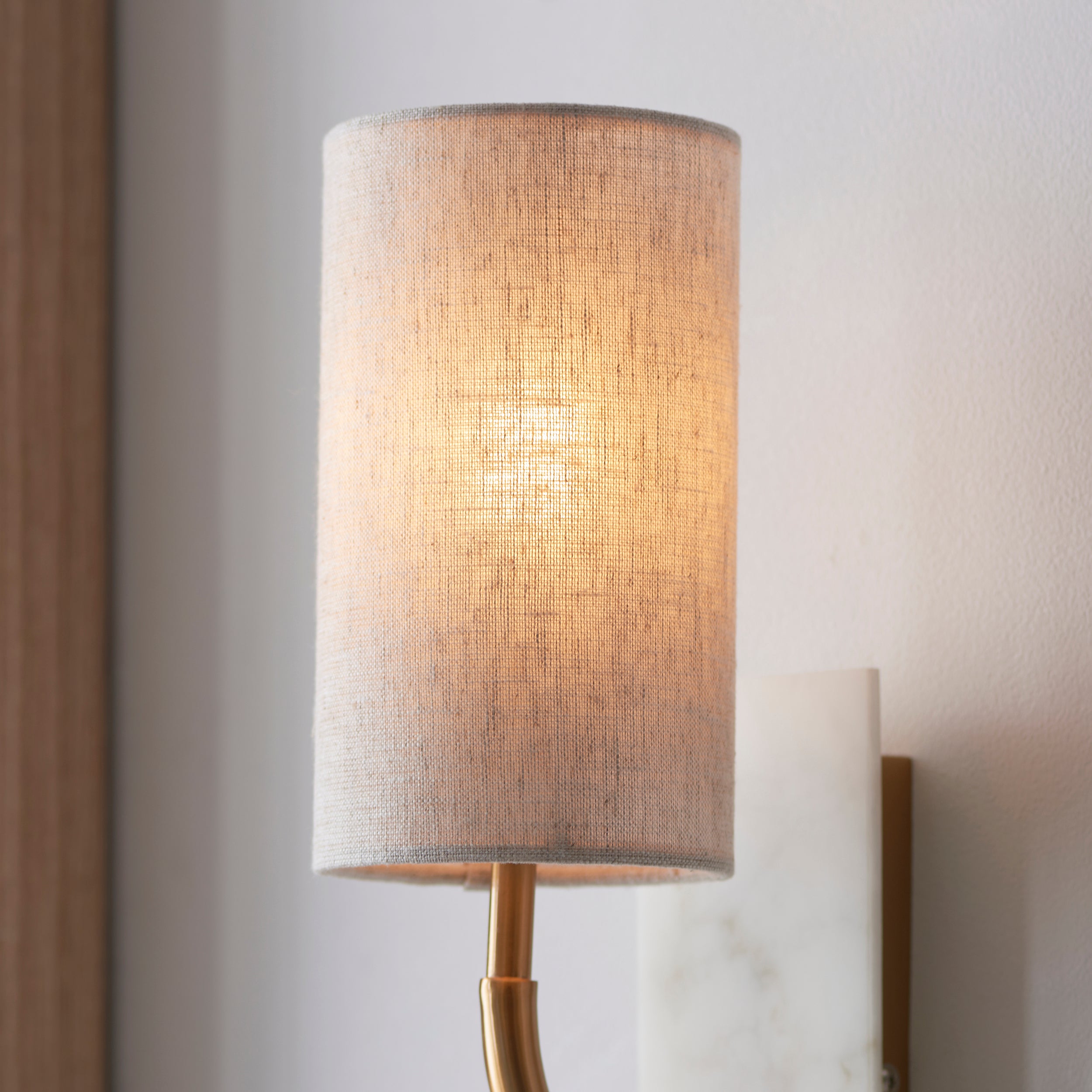 Utopia Spire Single White Marble Curved Arm Wall Light - Vintage Brass & Natural Cylindrical Shade