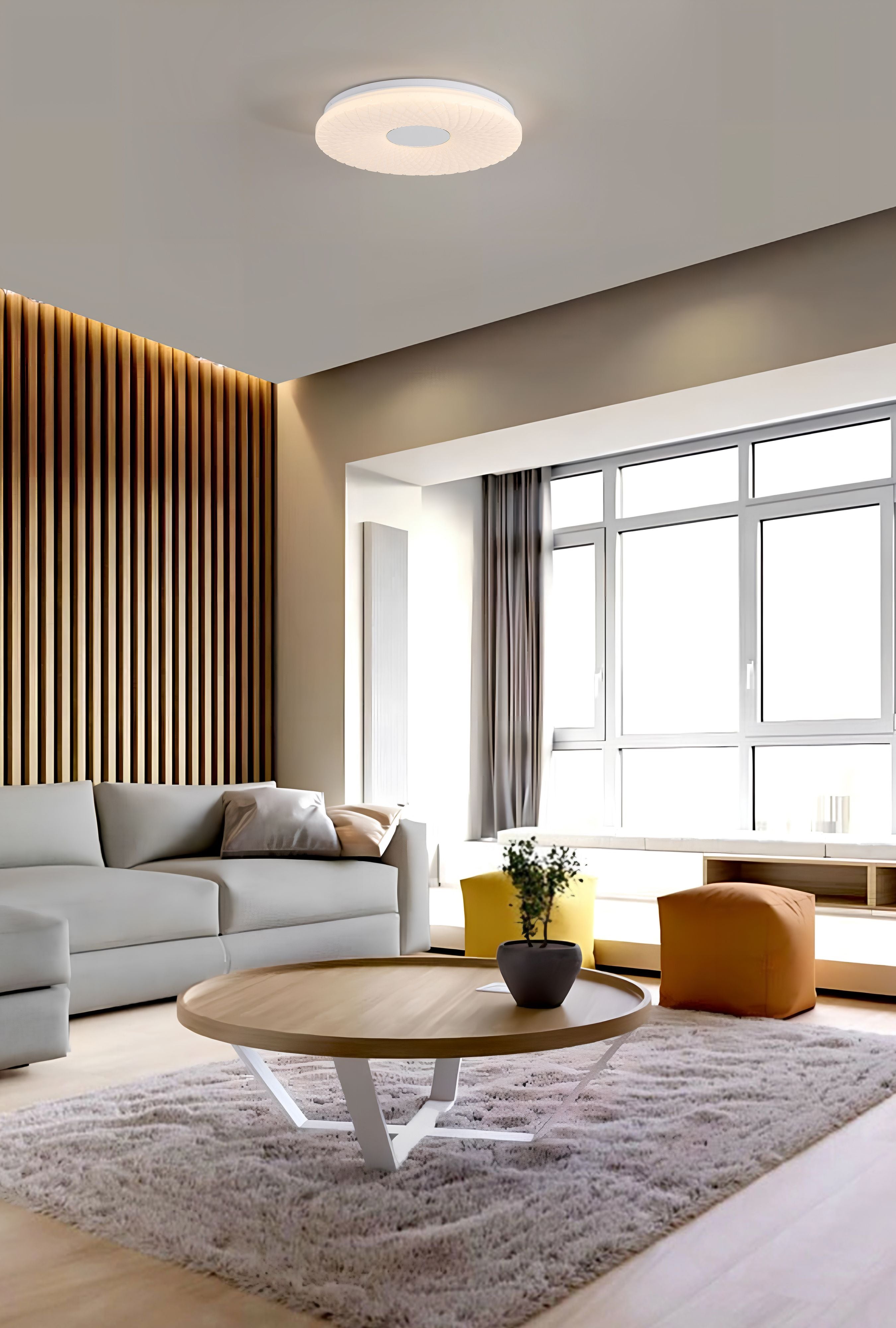 Halolux LED flush ceiling light fitted above a coffee table in a styled living room with a grey sofa and wood panelled wall