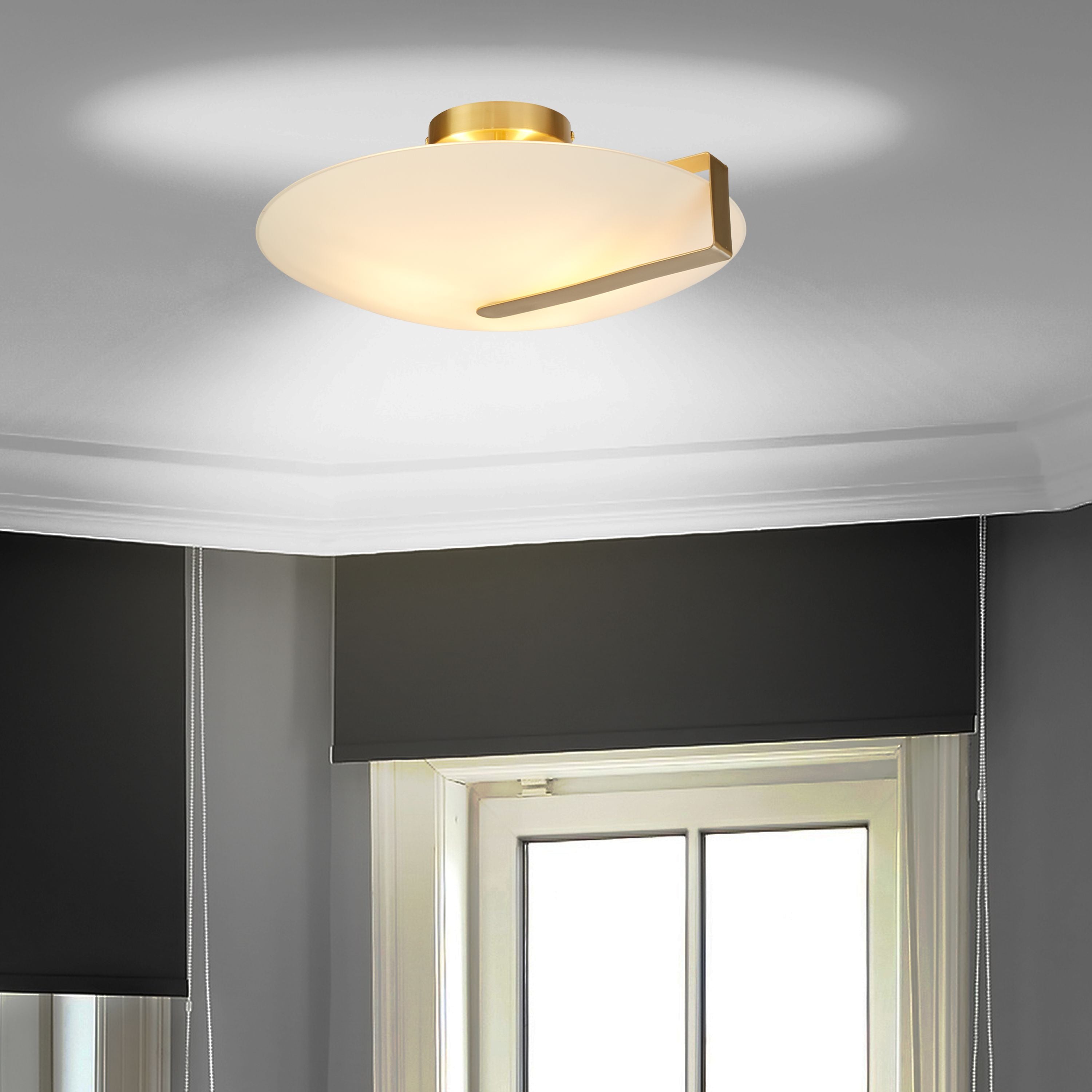 Searchlight Sundial flush ceiling light in gold with frosted glass, styled on a room ceiling above a window with roller blinds