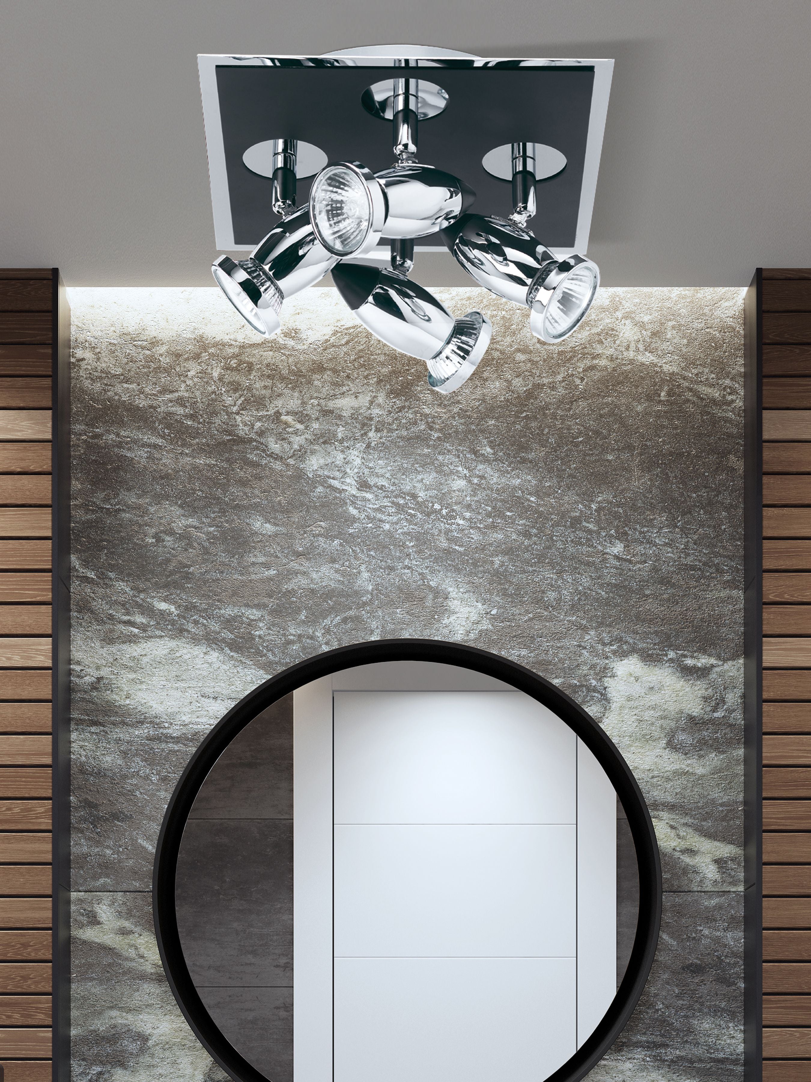 Searchlight Comet 4 light spotlight in matt black and polished chrome mounted above a round mirror in a styled marble effect room