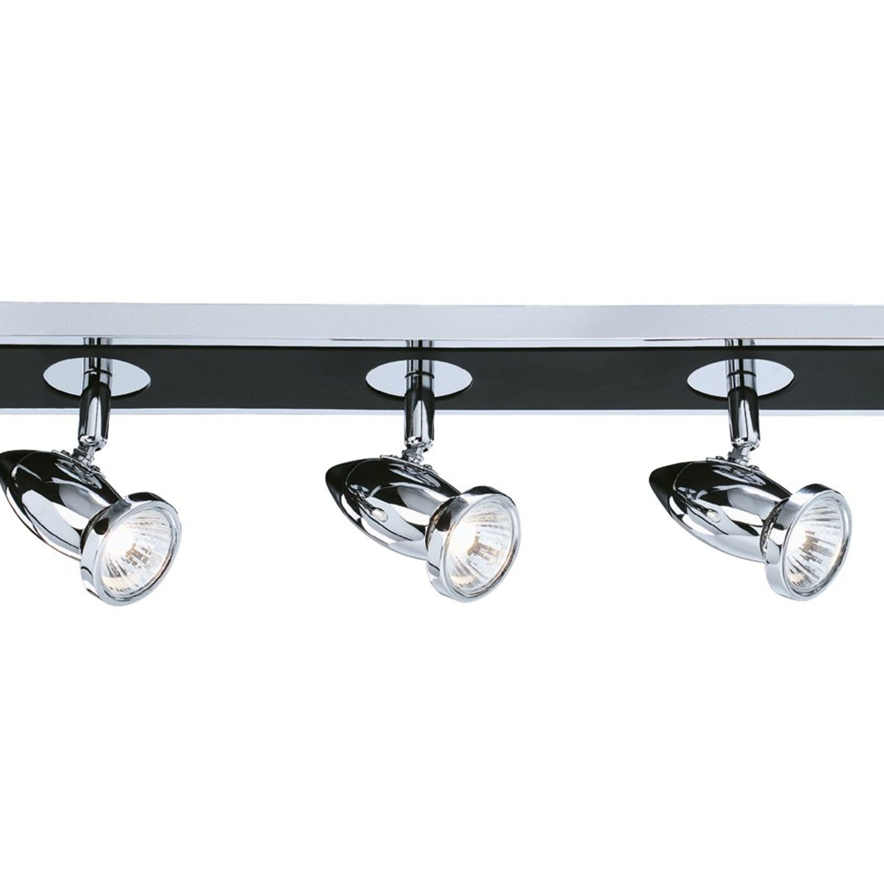 Close up of three polished chrome spotlight heads on the Comet 5 light bar, lit against the matt black bar
