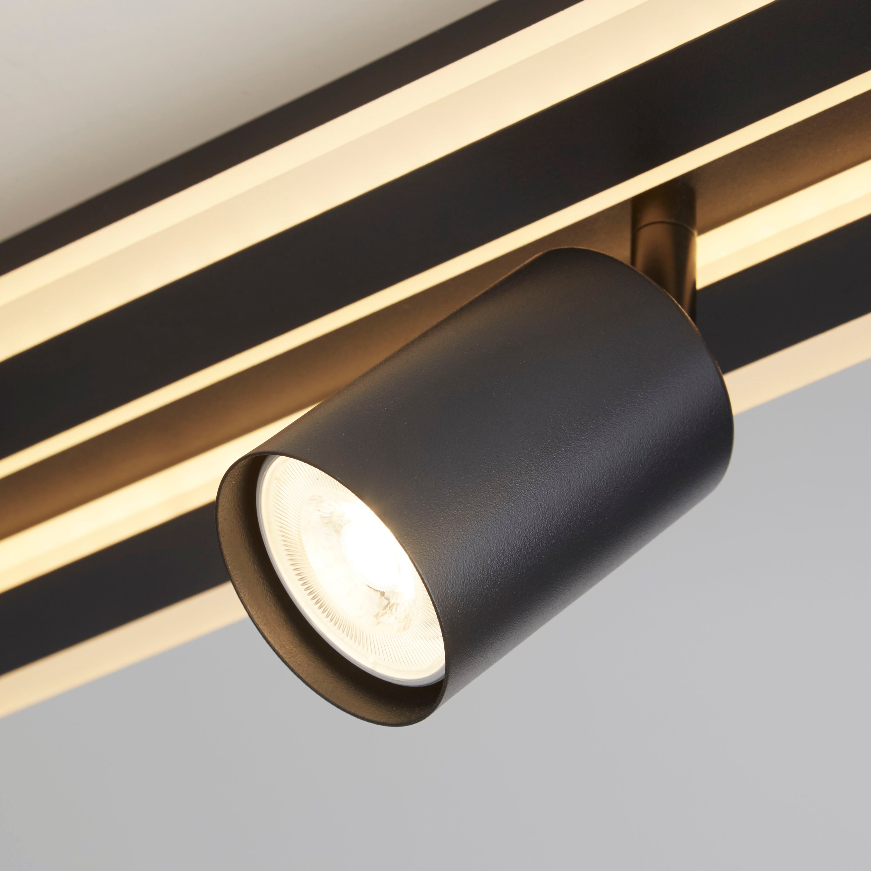 Close up of one adjustable GU10 spotlight head on the San Diego 4 light flush in matt black