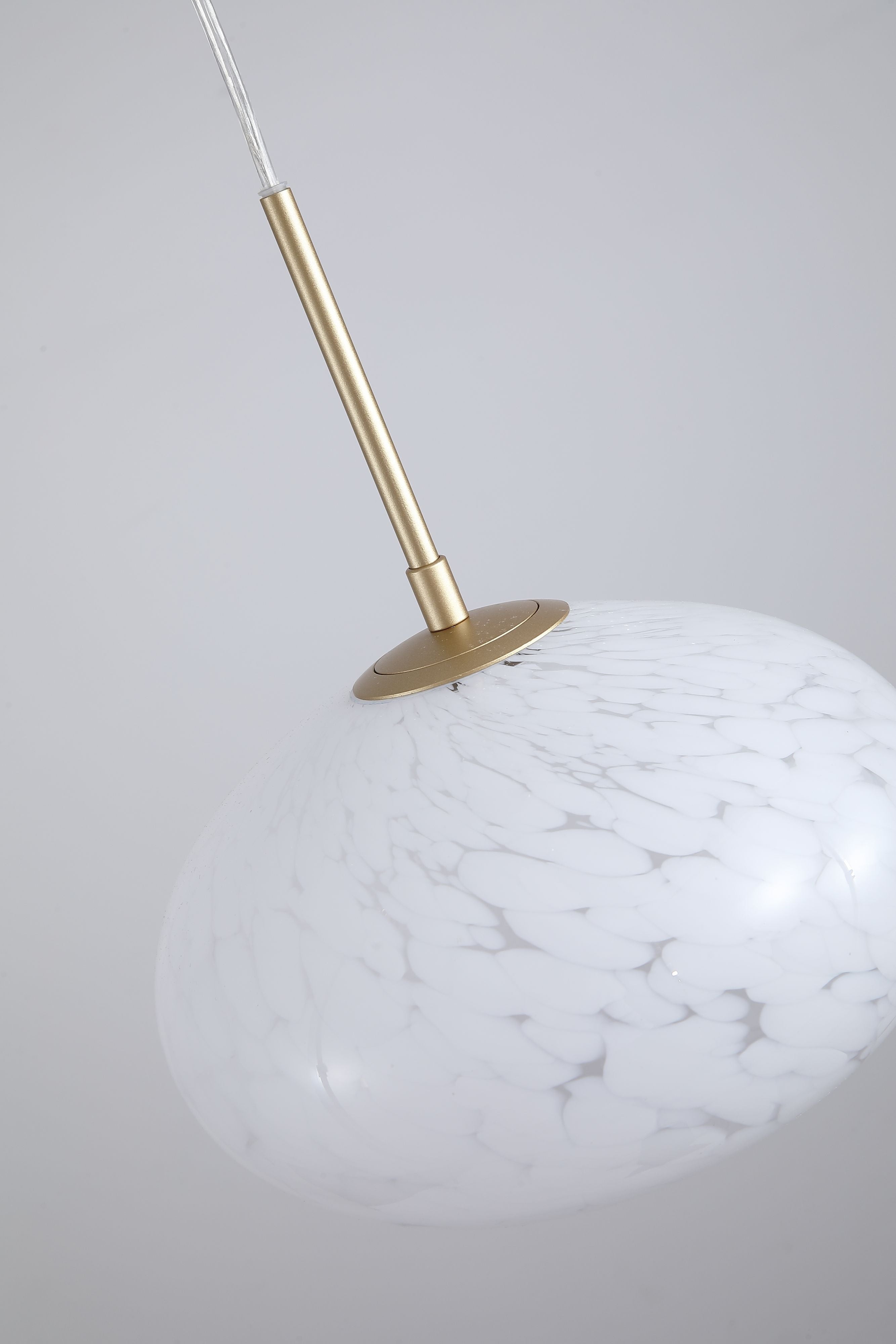 Close up of the Searchlight Confetti LED Pendant showing the gold ceiling plate, rod and mottled confetti glass texture