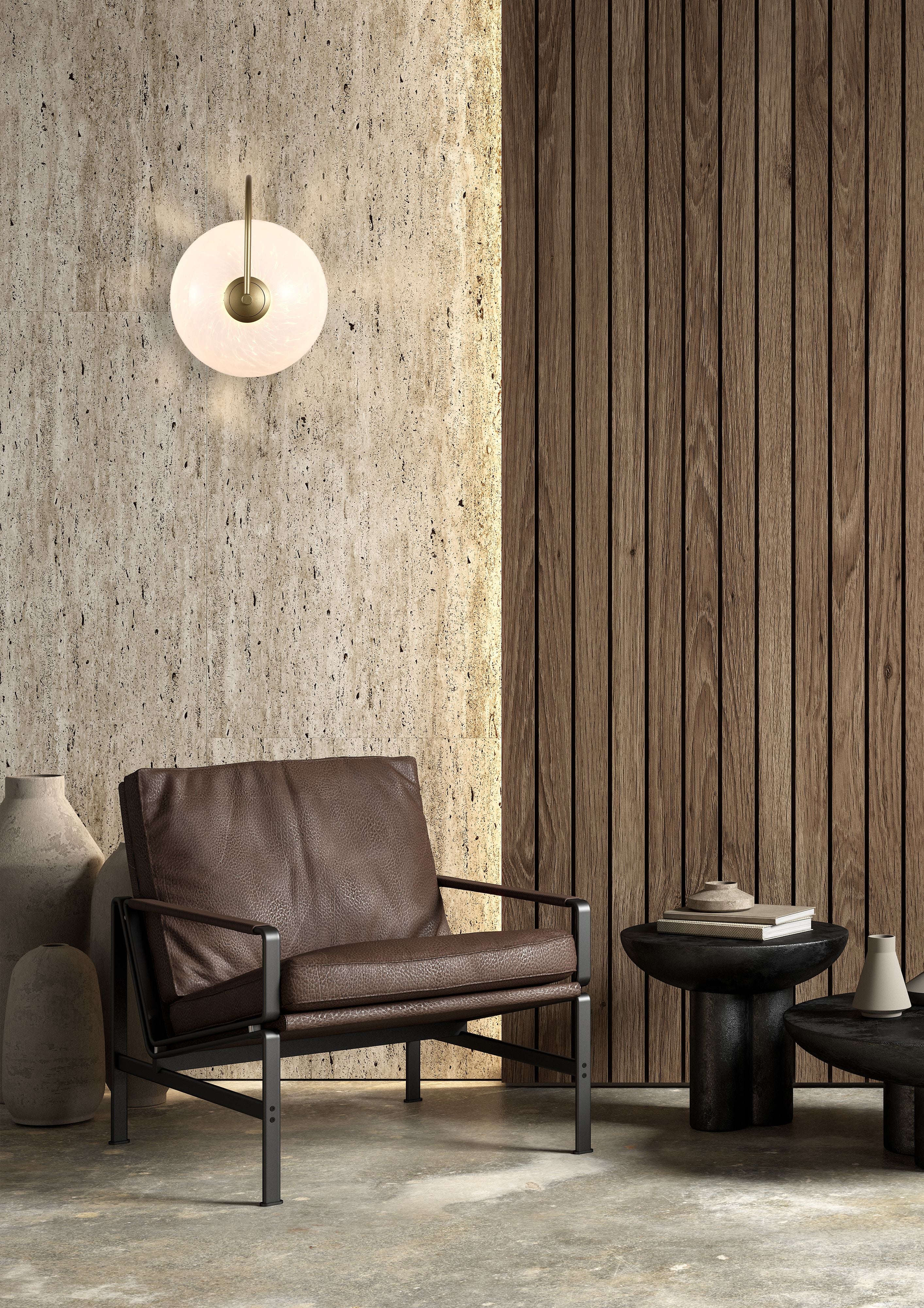 Searchlight Confetti LED Wall Light in gold mounted on a travertine stone wall beside wood paneling, with a brown leather armchair below