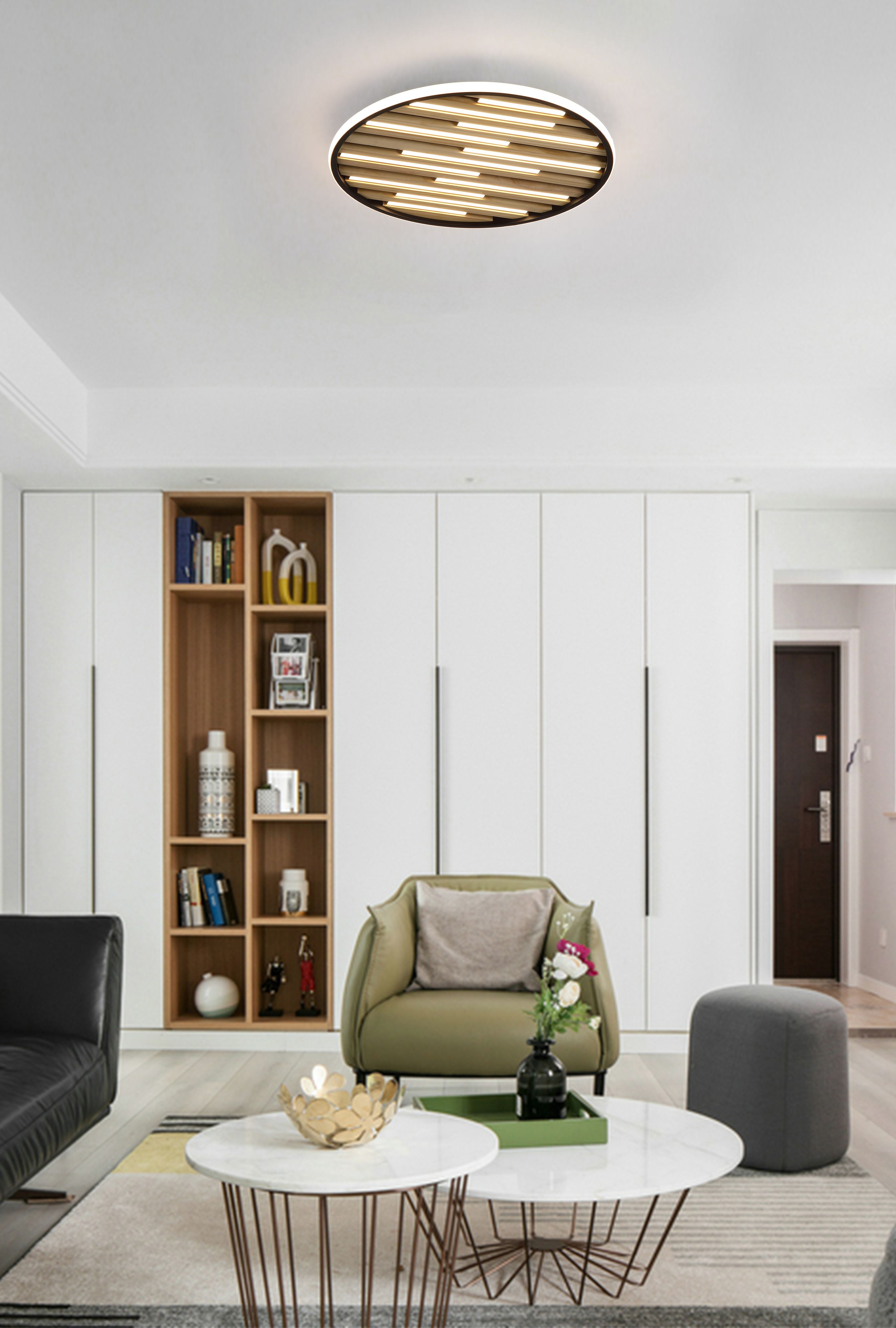 Searchlight Equalise LED flush ceiling light fitted in a styled living room with bookshelf, armchair and coffee tables, glowing warm white