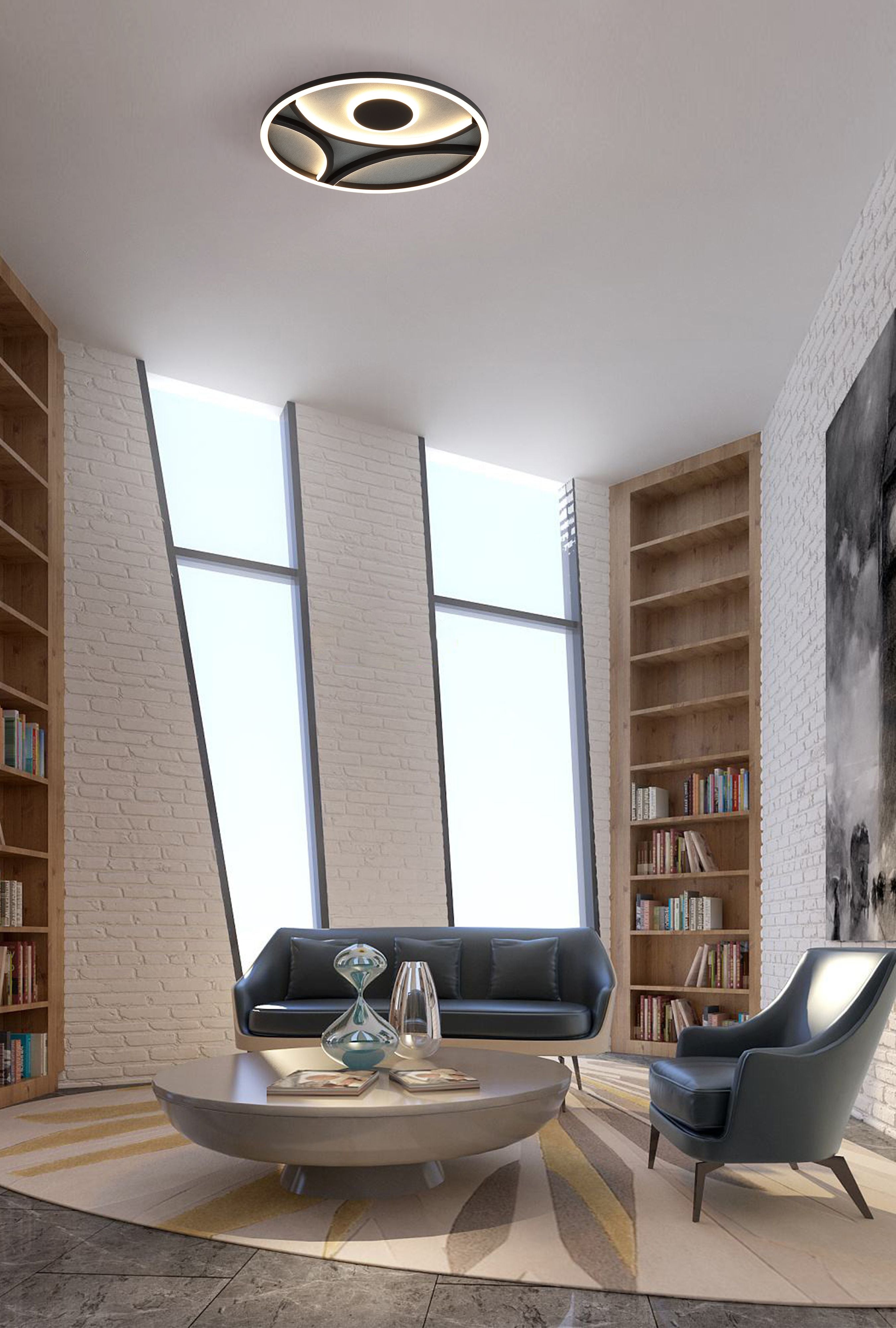 Zendisc LED flush light fitted above a dark leather sofa in a styled library style living room with tall bookshelves