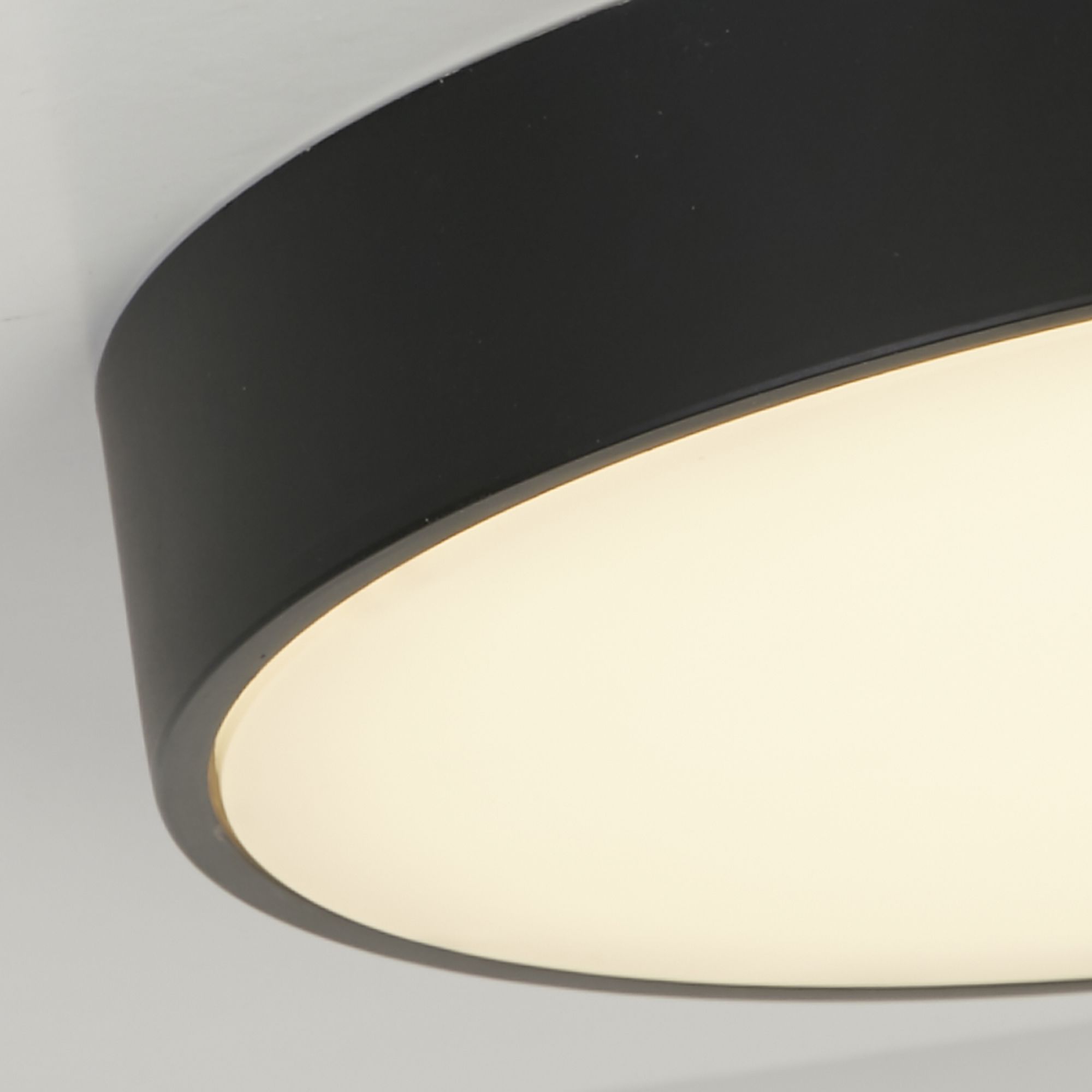 Close up of the Palma flush light's black rim and white diffuser edge