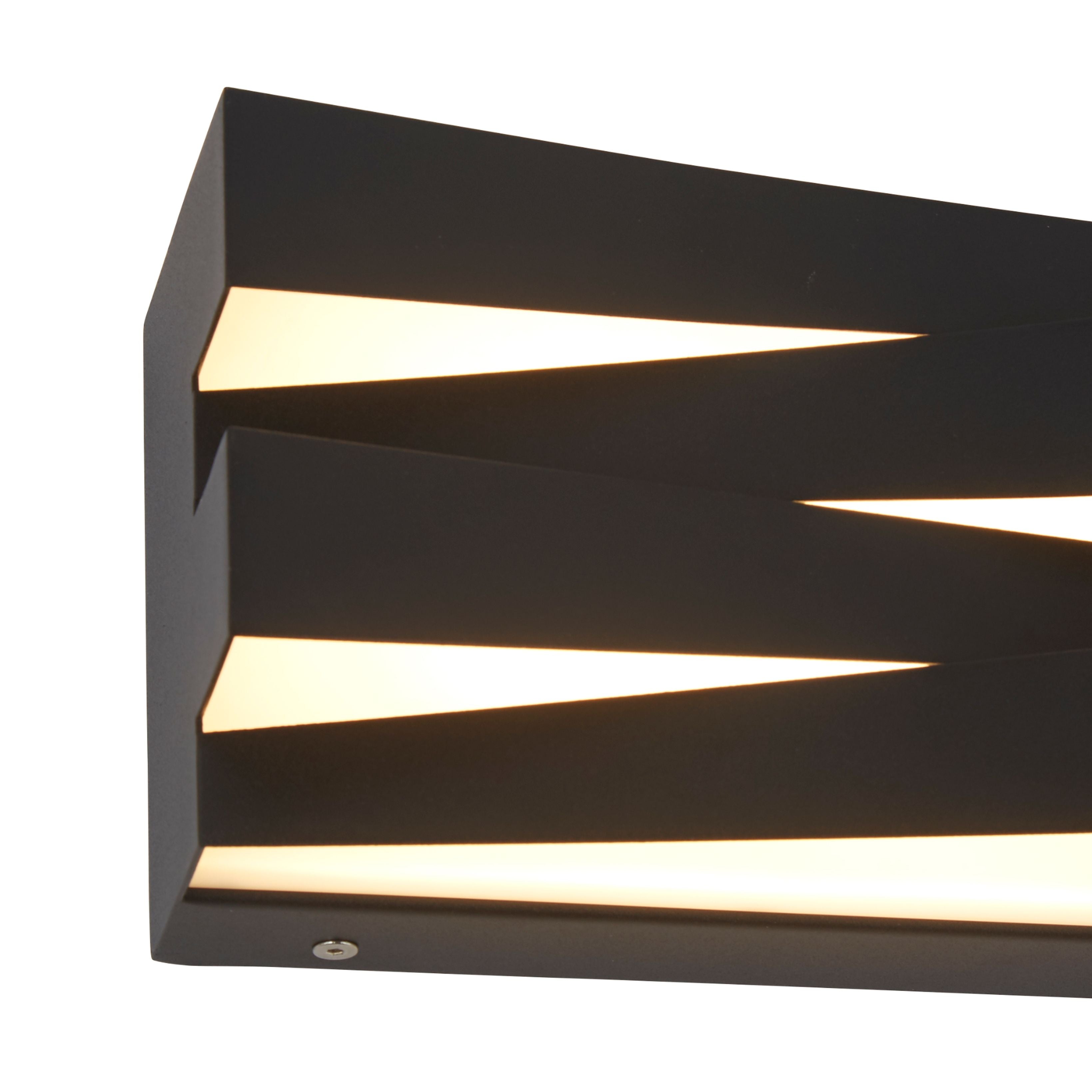Close up detail of the Section wall light's sand black iron frame and acrylic diffuser strips