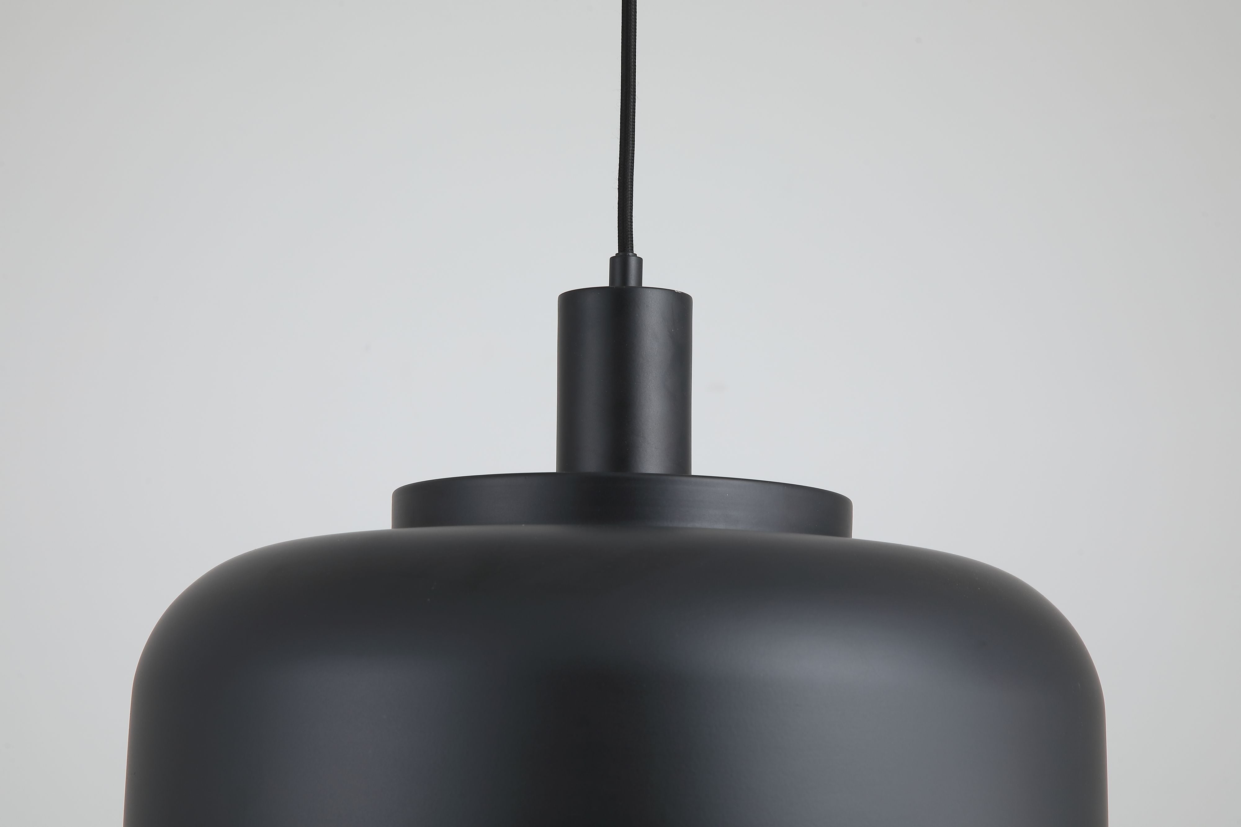 Close up of the Searchlight Scotland pendant's fitting, showing the matt black ceiling rose and cylindrical lamp holder above the dome shade