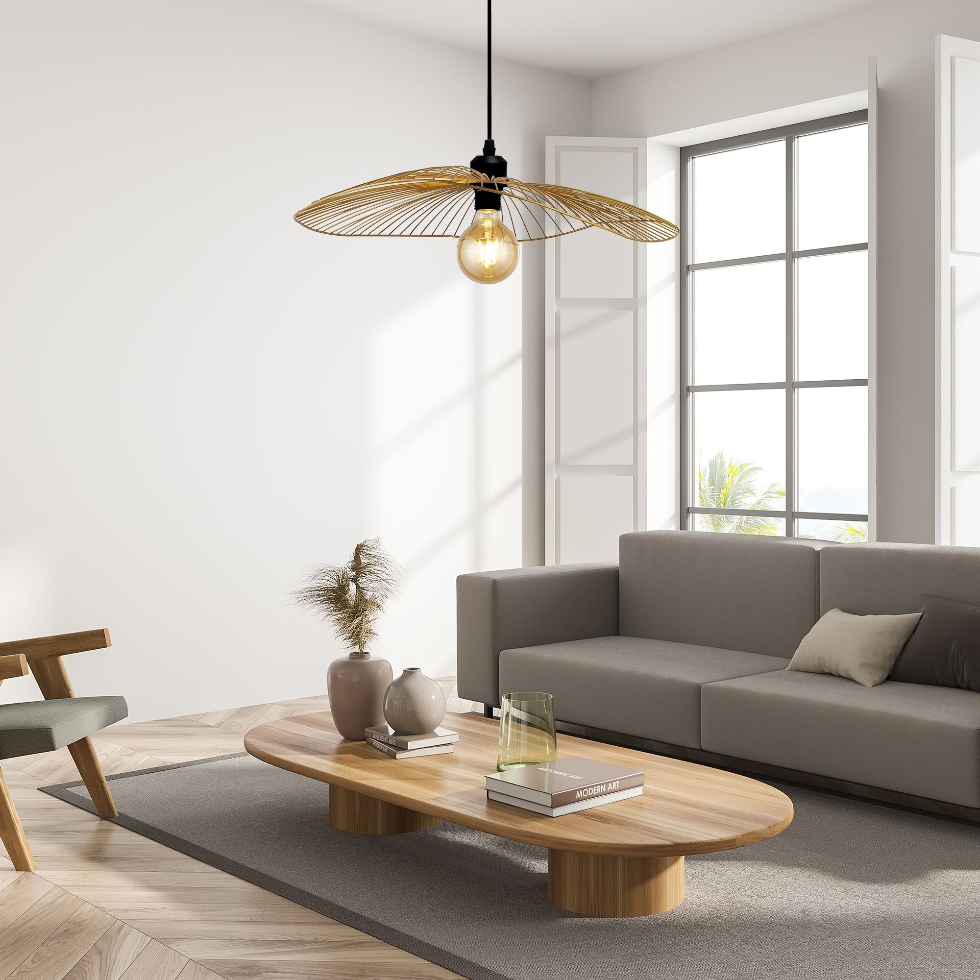 Searchlight Wave pendant in black and gold hung above a coffee table in a modern living room setting