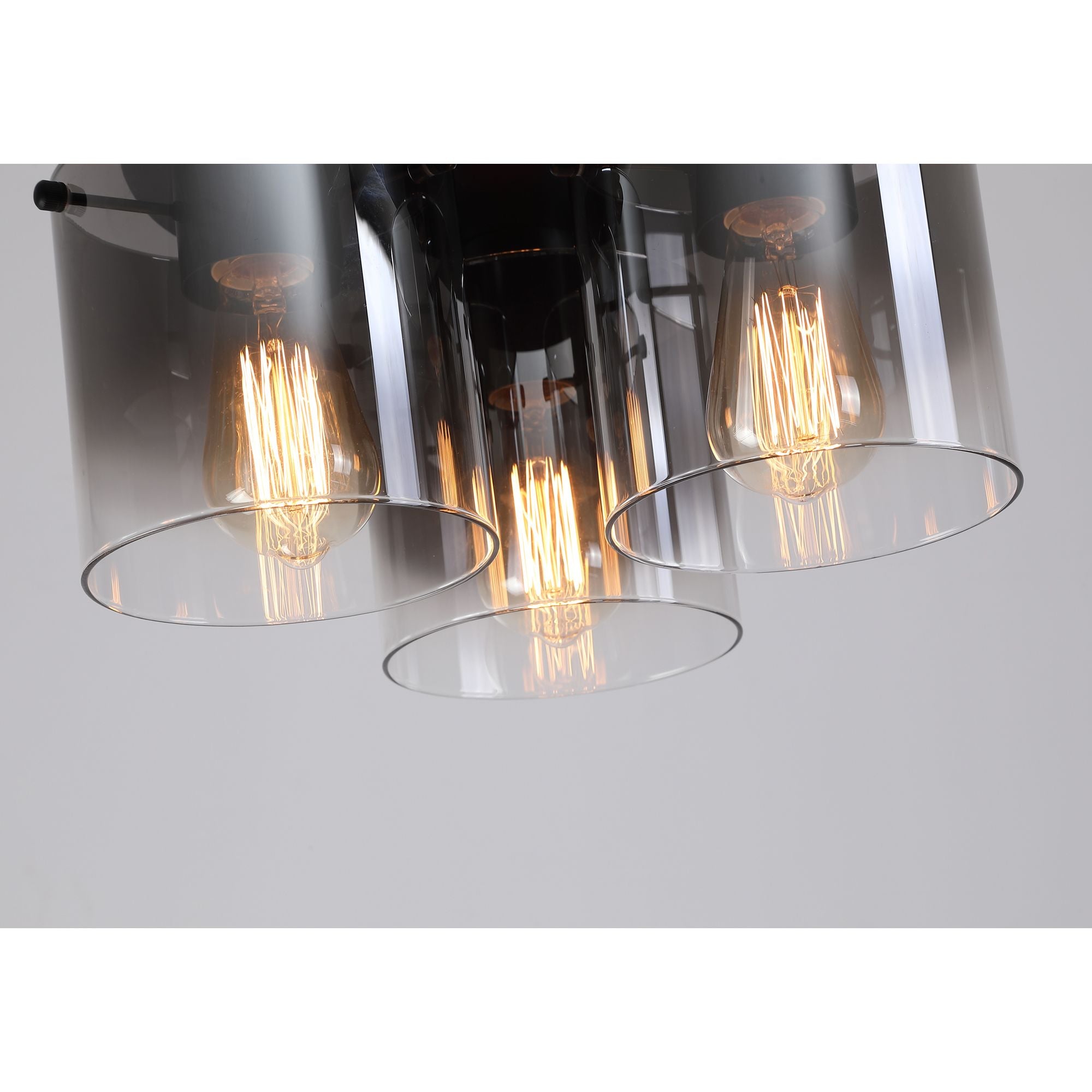 Close up angled view of the three smoked glass shades and filament bulbs on the Searchlight Sweden 3 Light Flush