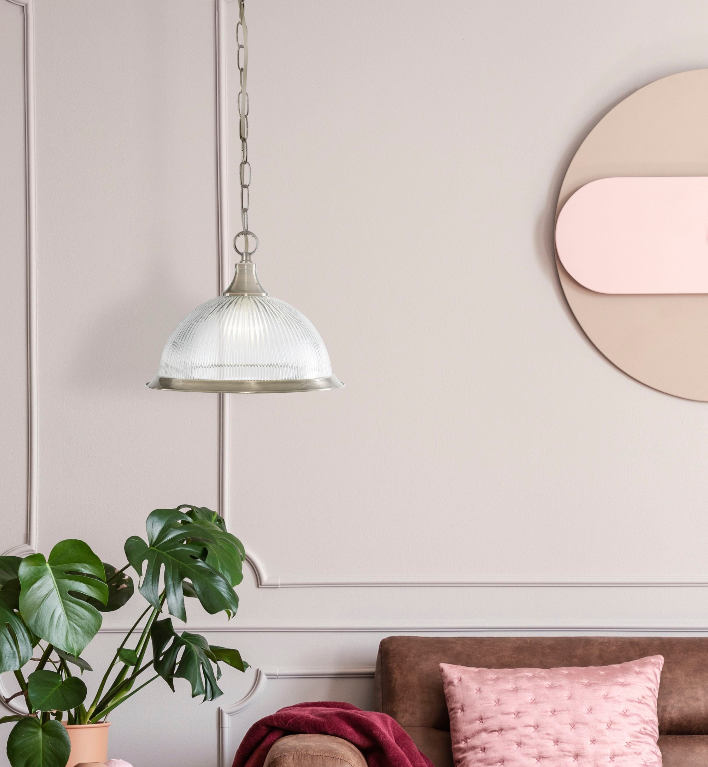 American Diner pendant hanging in a pink toned room beside a monstera plant and round wall mirror