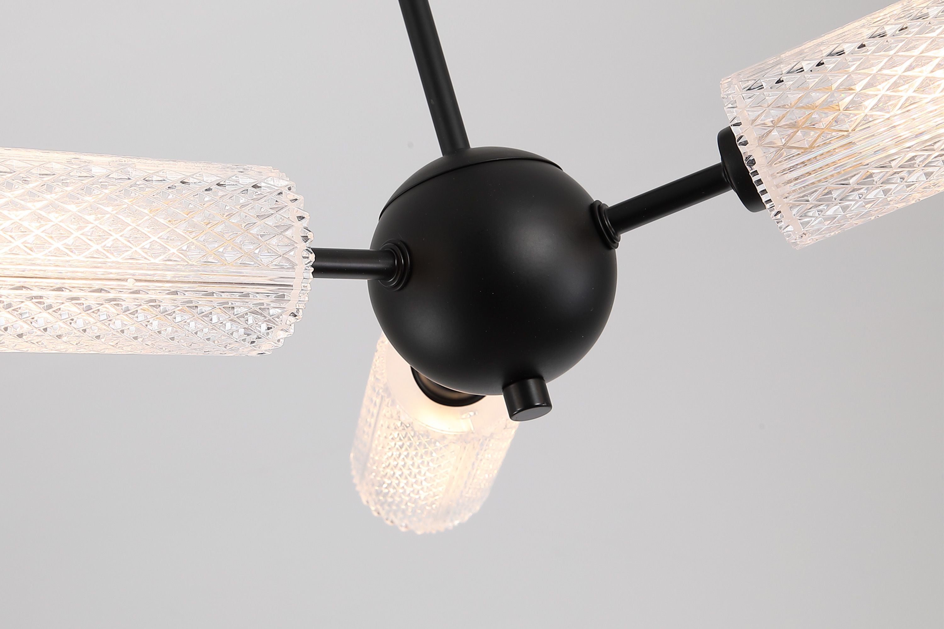 Close up of the black iron sphere and textured acrylic shades on the Cosmic 3 light ceiling fitting