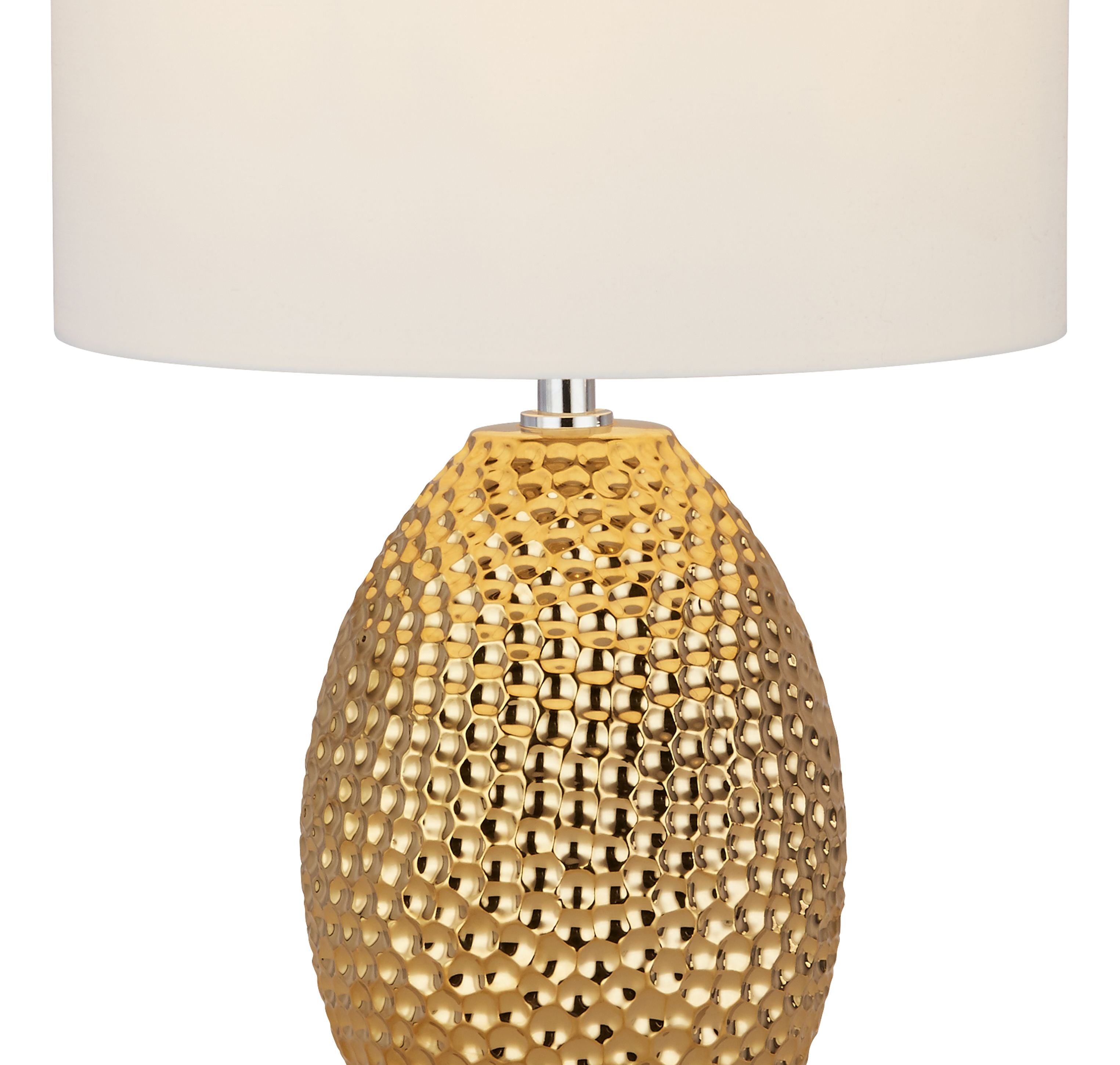 Close up of the Nadine lamp's dimpled, textured gold base beneath the cream fabric shade