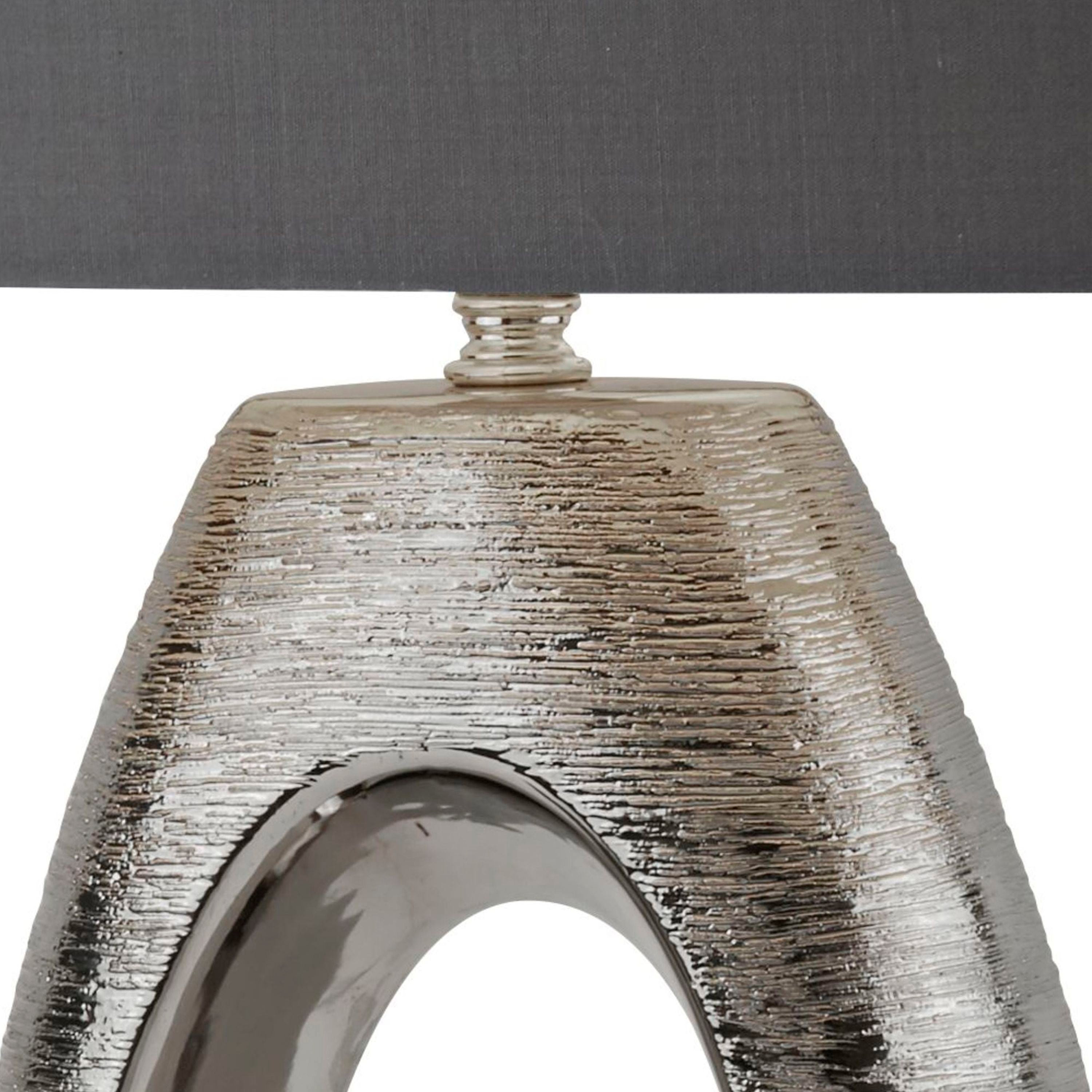 Close up of the Artisan lamp's brushed silver texture and polished chrome inner edge around the oval cut out