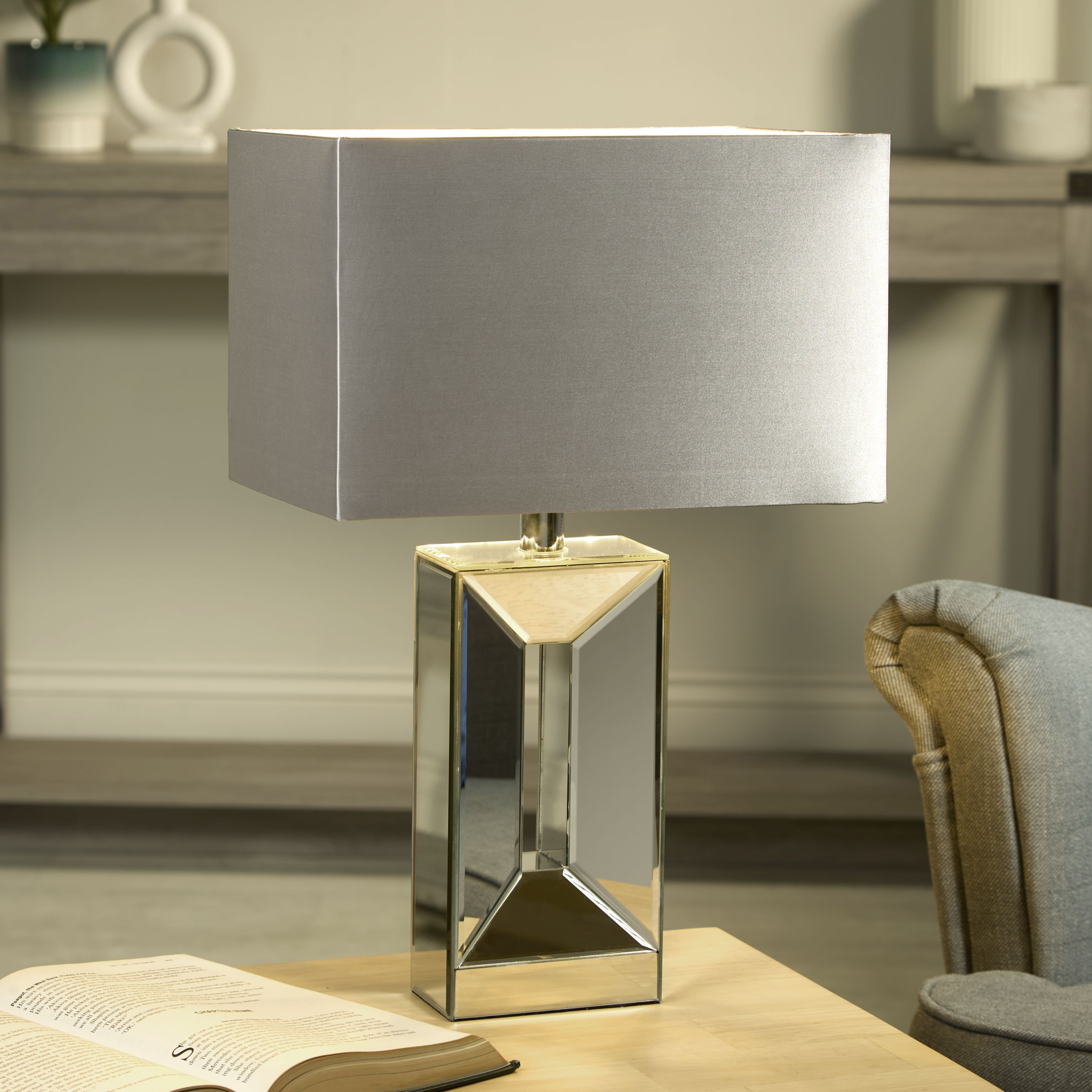 Searchlight Megan table lamp lit and styled on a wooden desk beside an open book and armchair