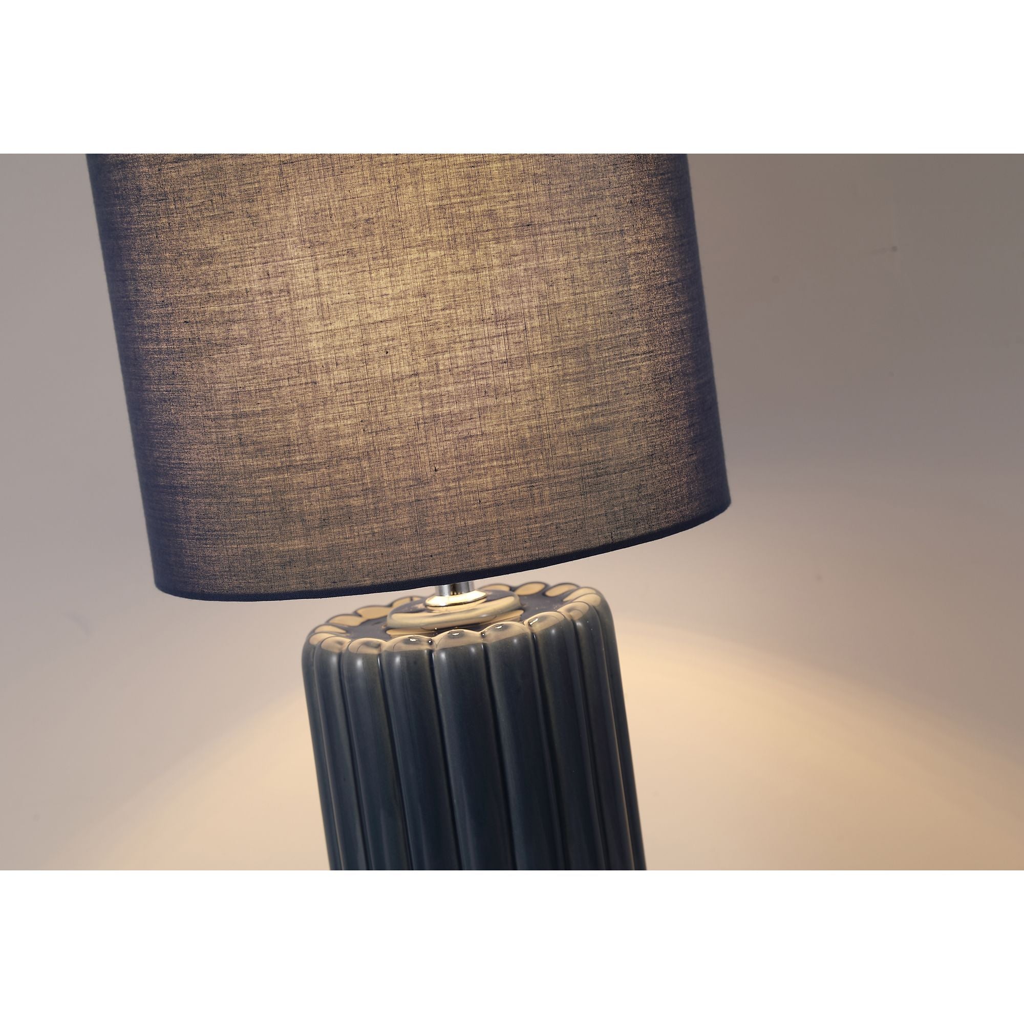 Close up of the Groove navy blue table lamp, showing the fluted ceramic neck and where the fabric drum shade meets the fitting