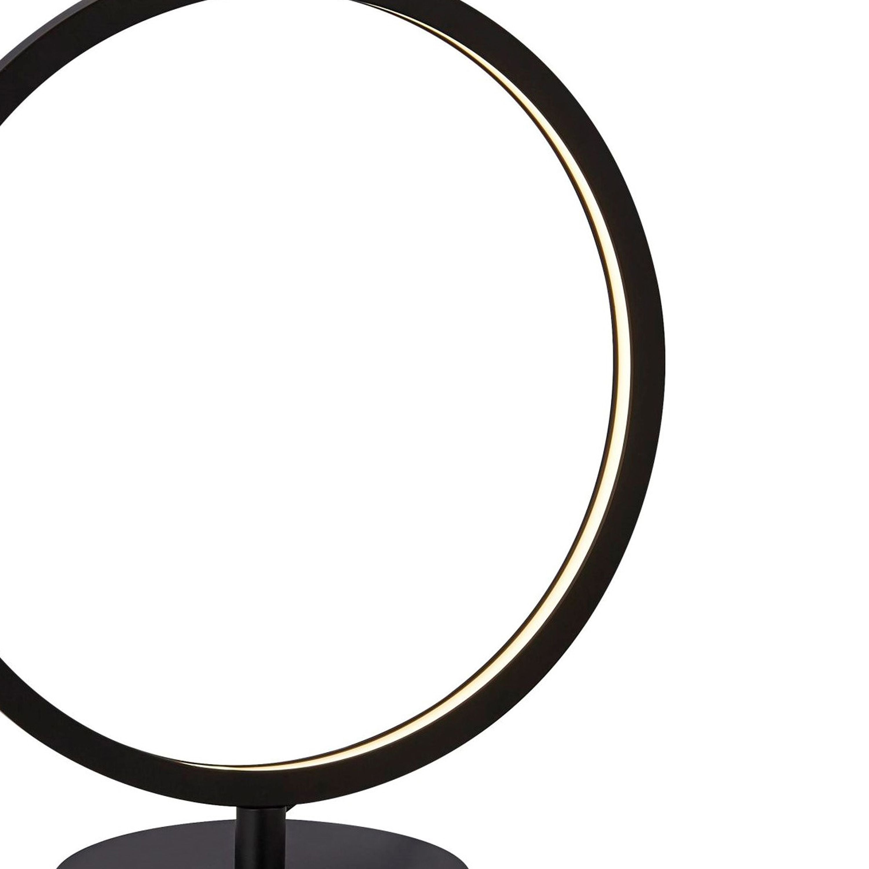 Close up of the Searchlight Cirque table lamp's opal silicone light strip glowing warm white against the black metal ring